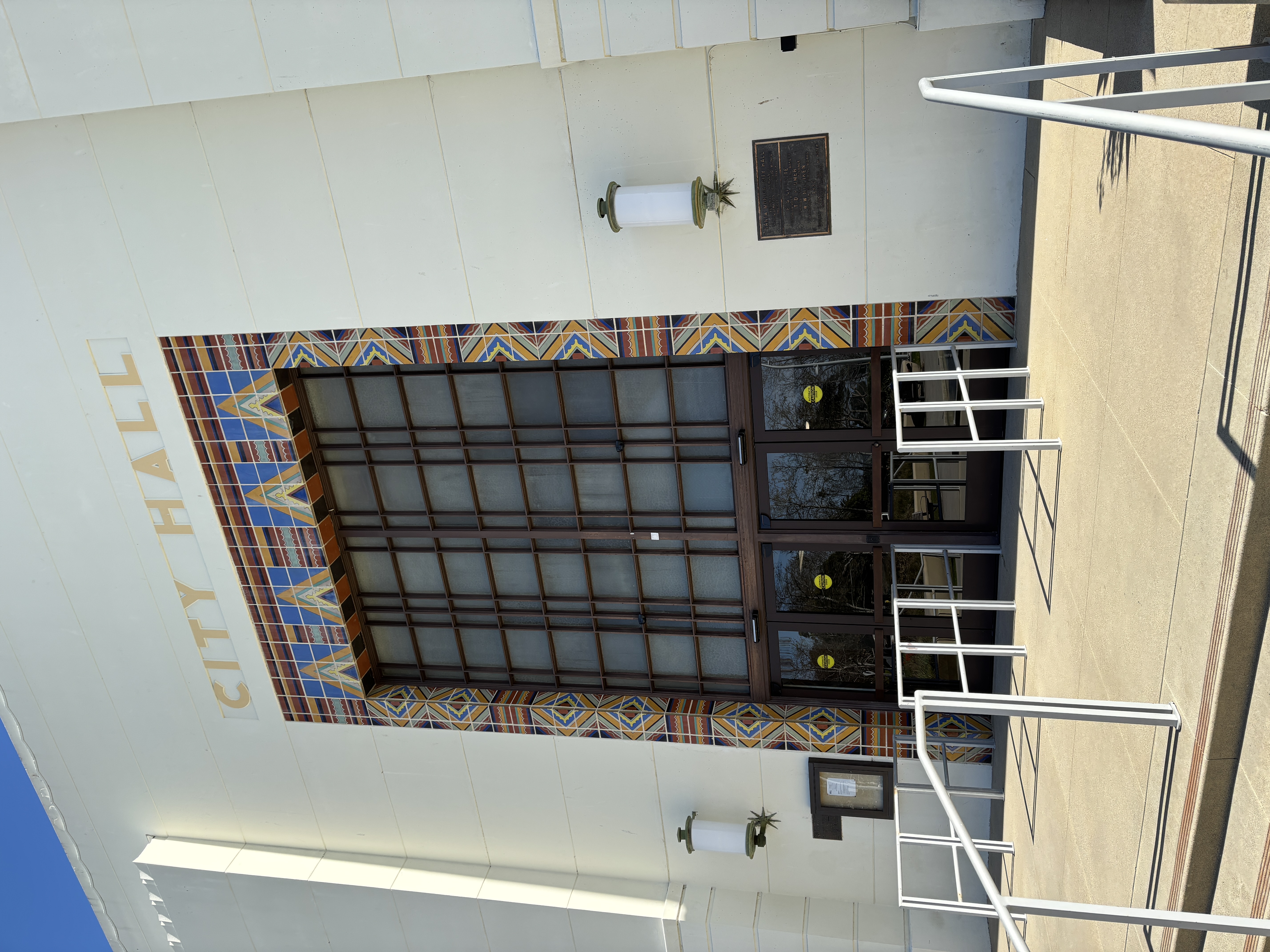 Art Deco entrance of Santa Monica City Hall with gold lettering above ornate tiled doors.