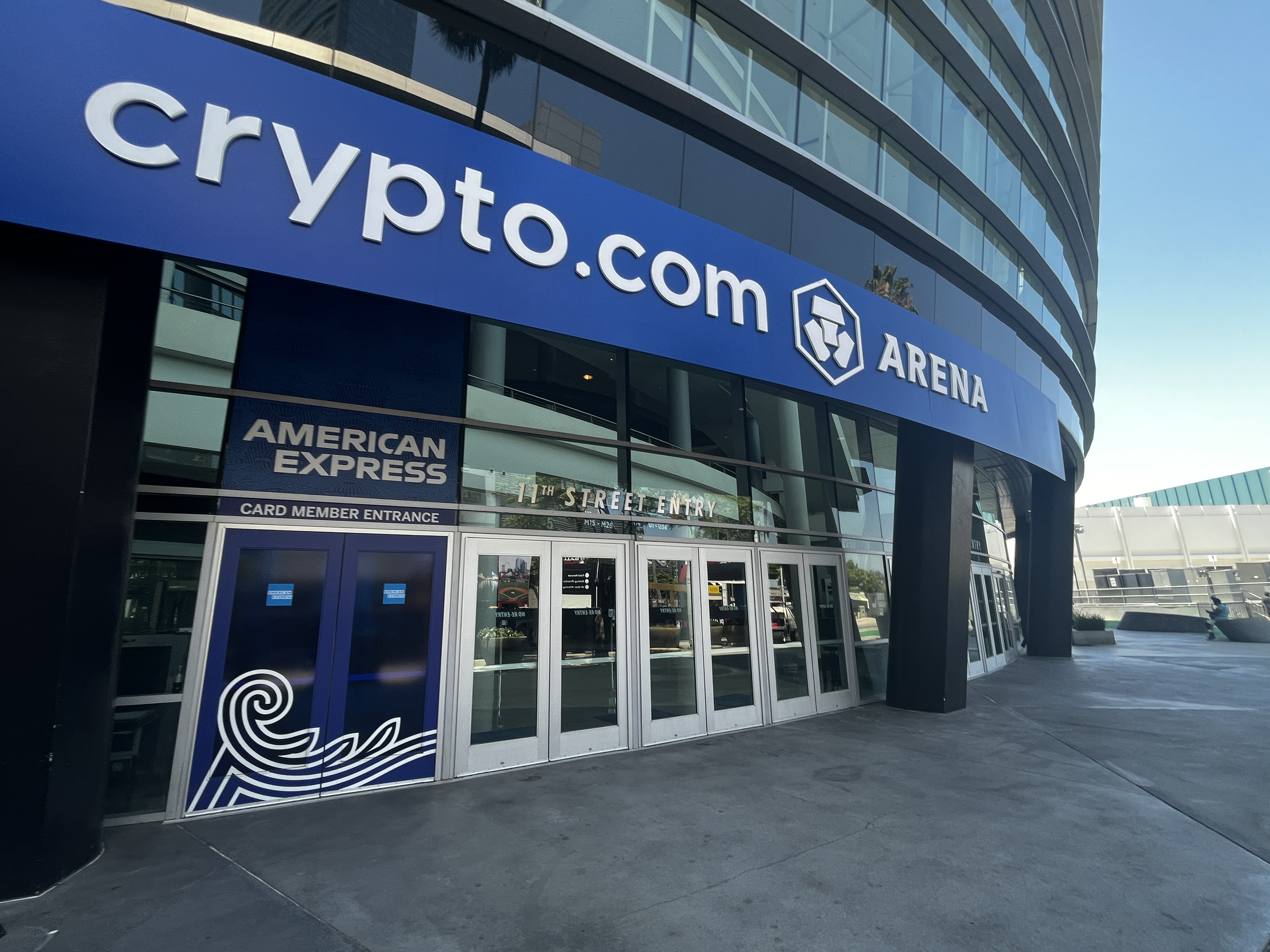 Daytime exterior of Crypto.com Arena showing the venue name on a blue facade.
