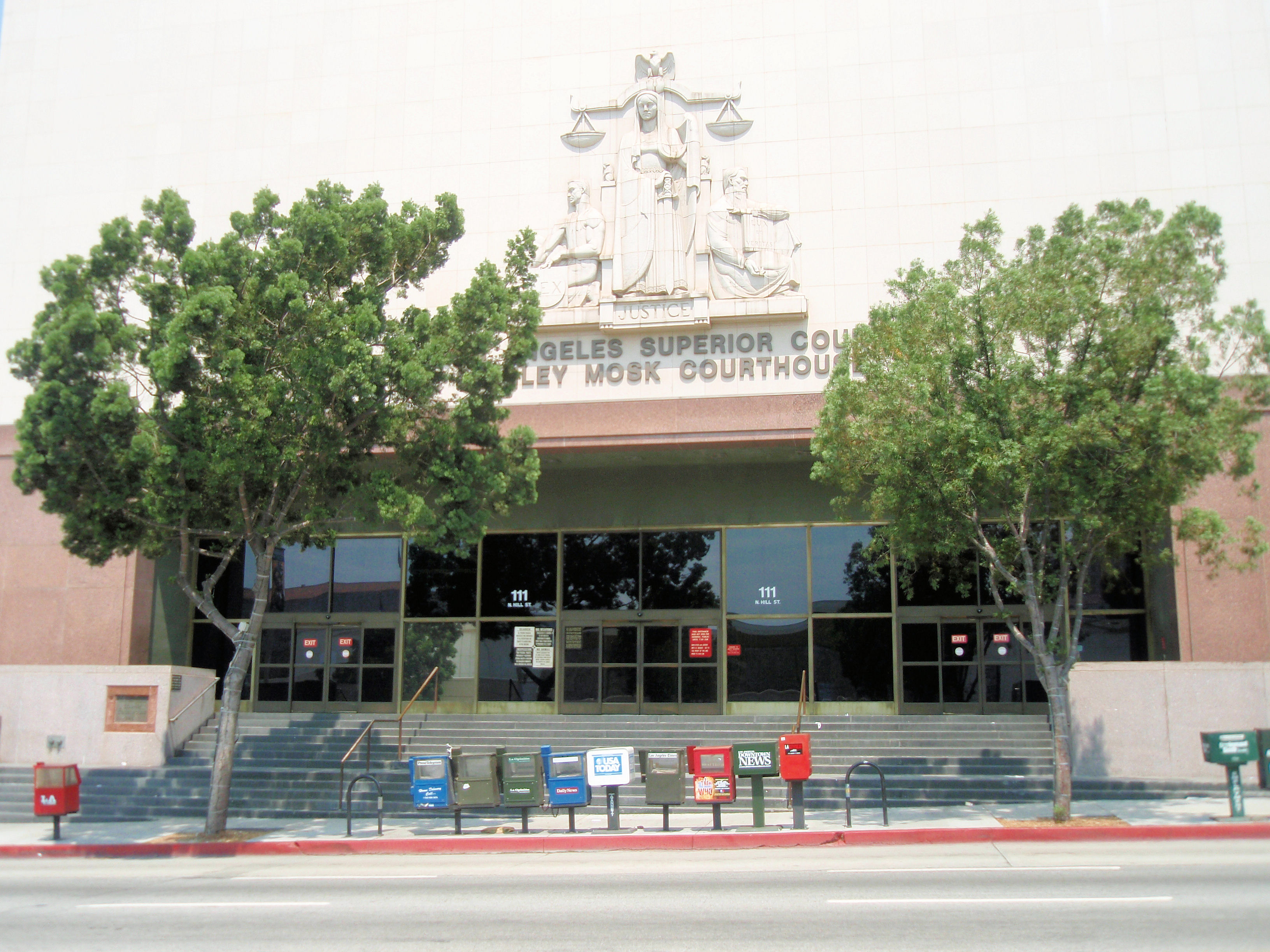 Exterior of a large courthouse building with wide entrance steps and trees.