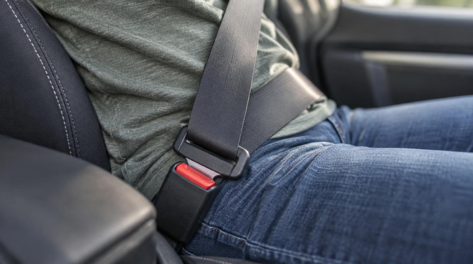 Close-up of a fastened seat belt buckle clicked into its latch.