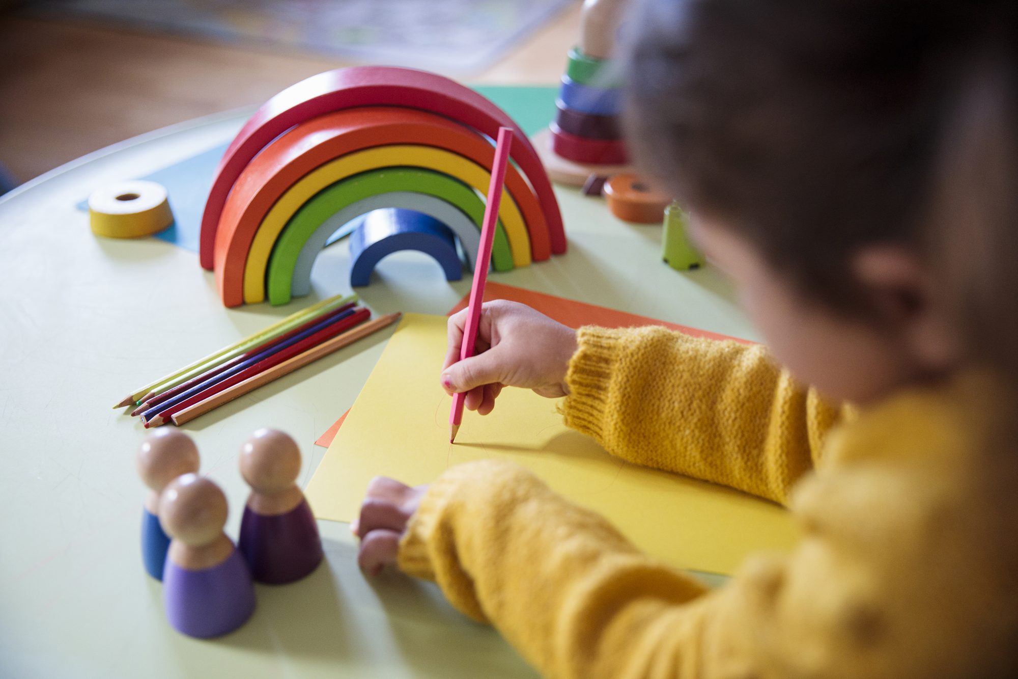 Preschooler painting and coloring.