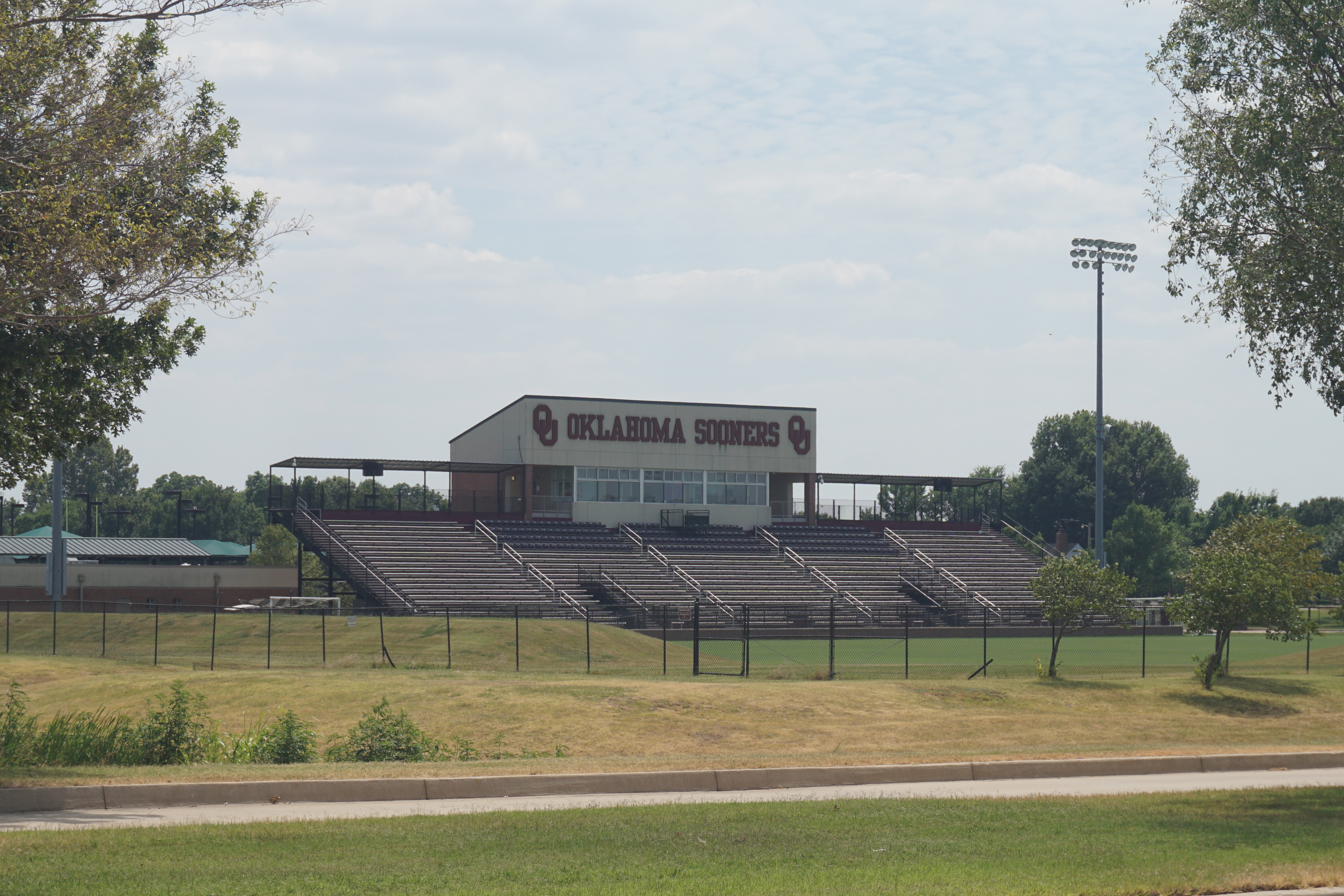 Bleachers and press box at a soccer stadium with Oklahoma Sooners signage.