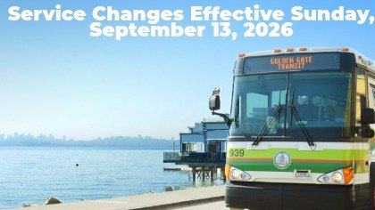 A Golden Gate Transit bus parked near a waterfront, with text announcing service changes effective September 13, 2026.