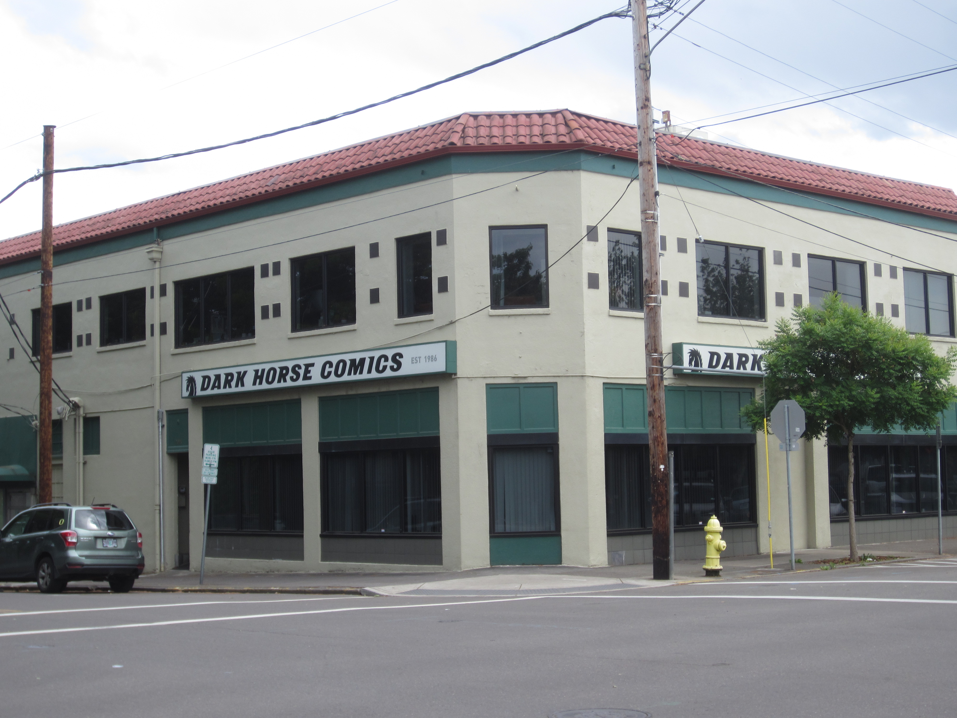 Two-story corner building with Dark Horse Comics signage and green awnings.