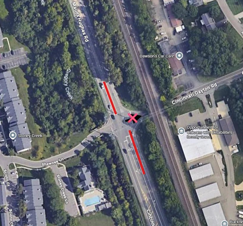 Aerial map of an intersection with red markers indicating two closed turn lanes.