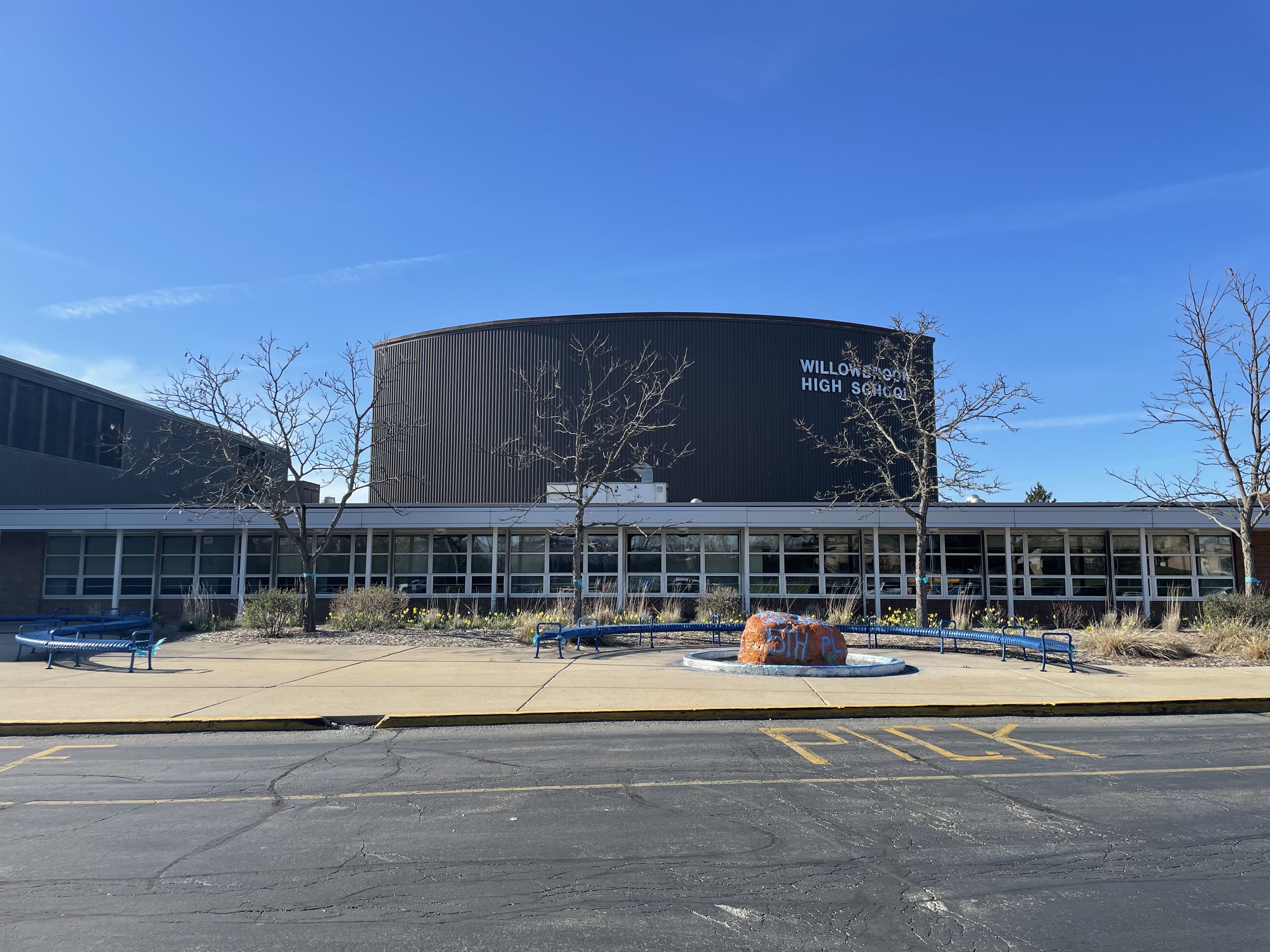 Exterior of Willowbrook High School showing curved facade with school name and glass entrance.