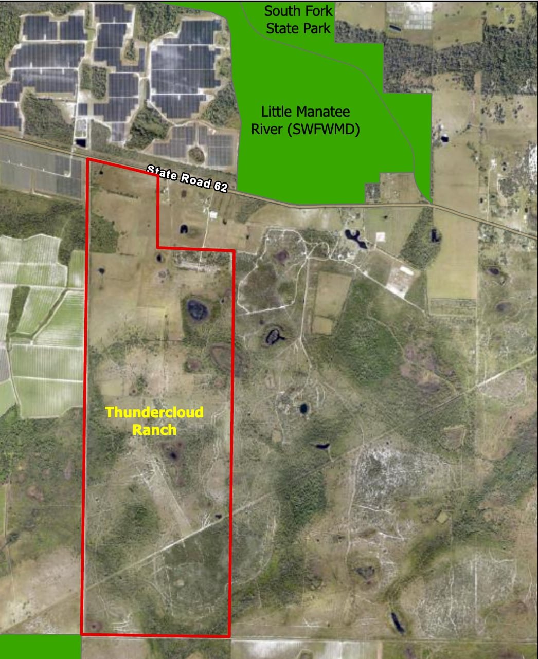 Satellite aerial map with a red boundary outlining a large rural property next to green-highlighted conservation areas.