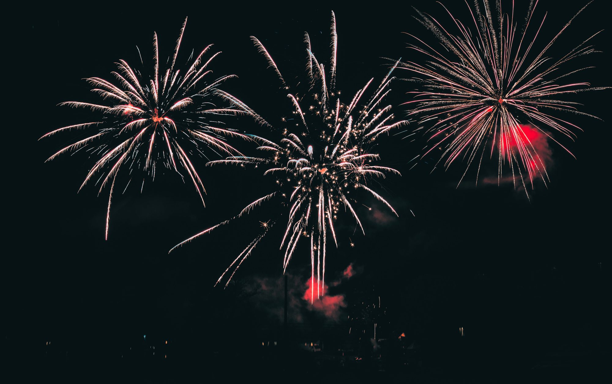 Vibrant fireworks illuminating the night sky with colorful bursts.