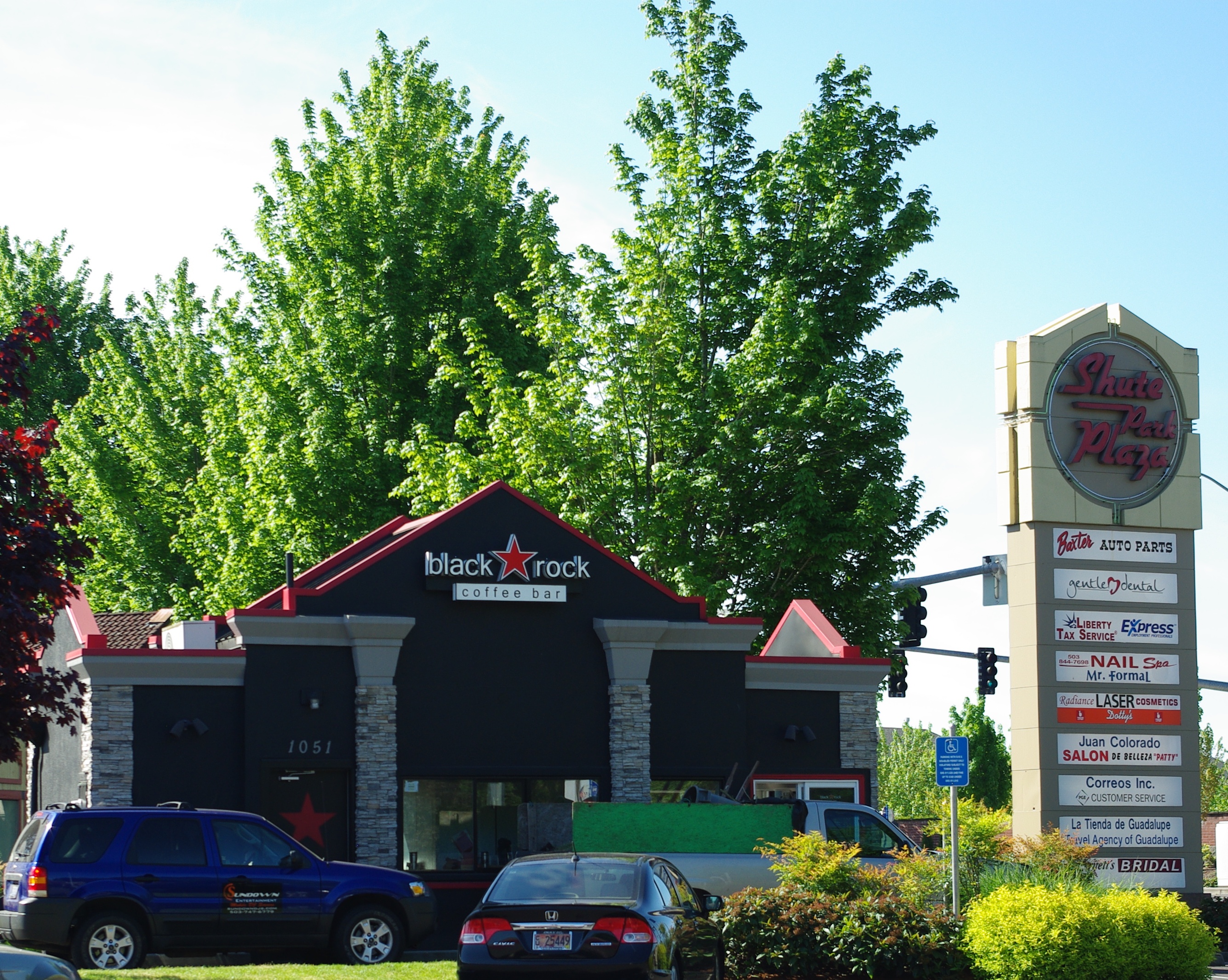 Black Rock Coffee Bar drive-thru building with black and red exterior and signage.