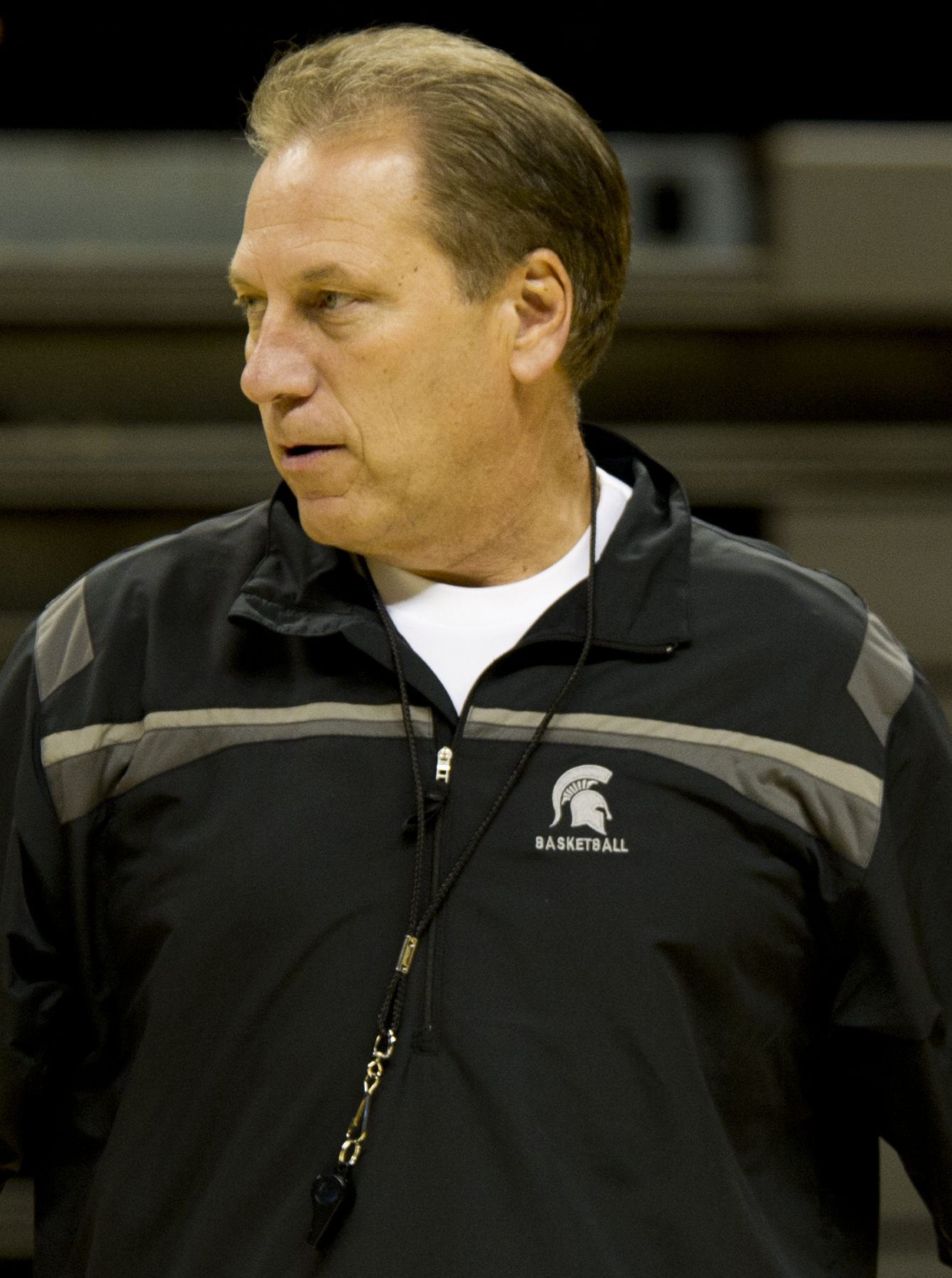 Man in a black Michigan State Basketball jacket with a whistle lanyard around his neck.