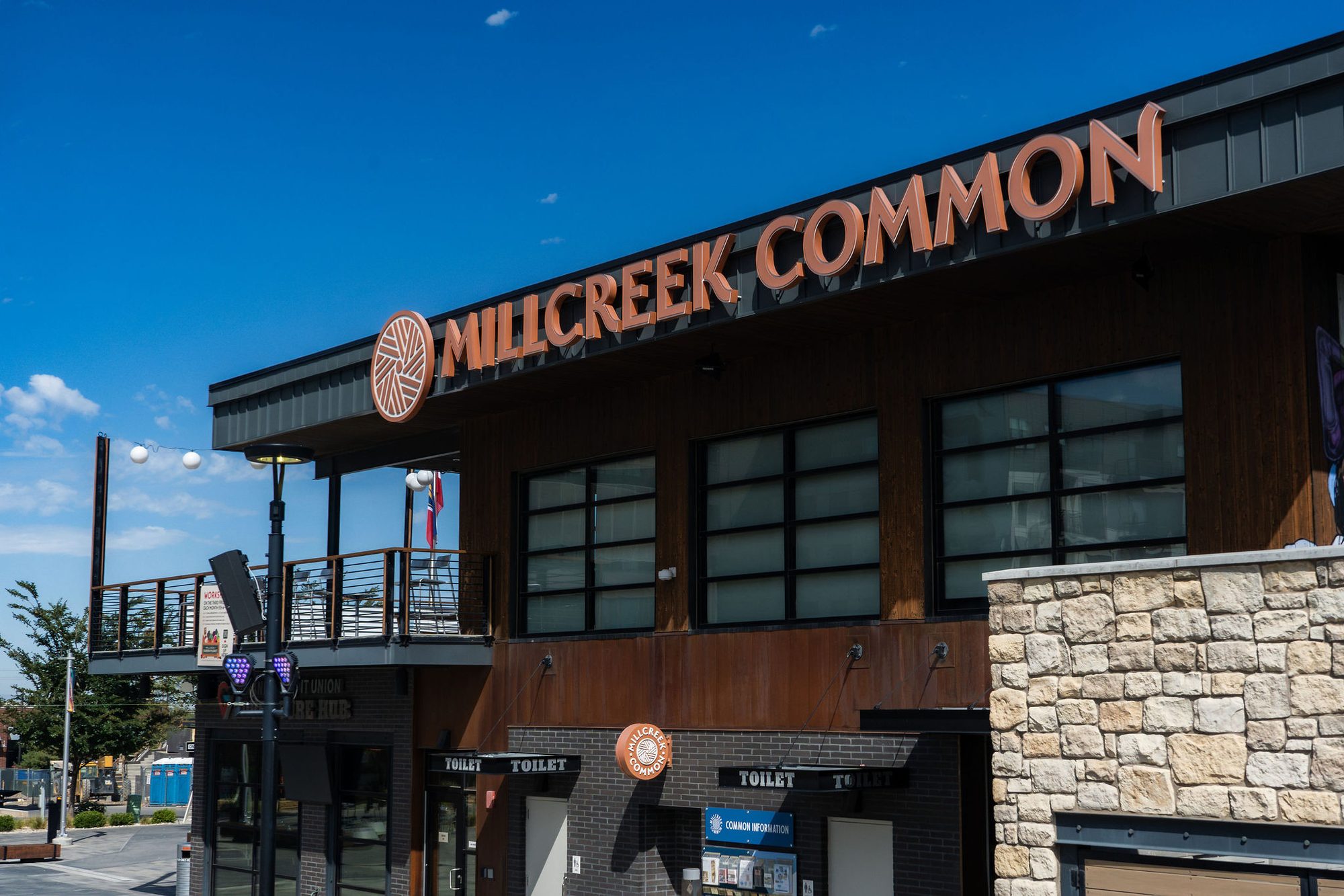 Exterior of a two-story mixed-use commercial building on a sunny day.