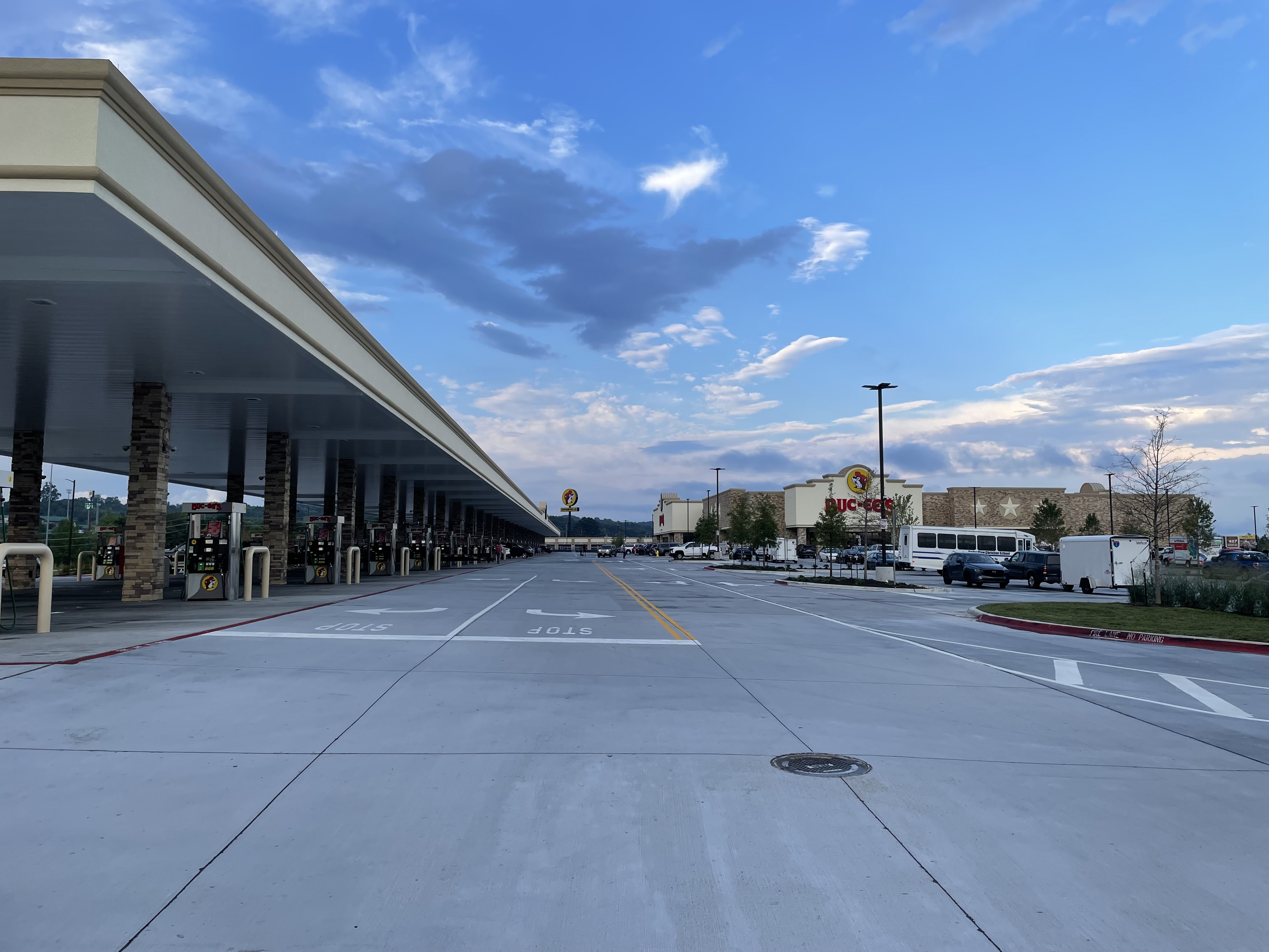 Large Buc-ee's convenience store building and fuel pump canopy in a wide parking lot.