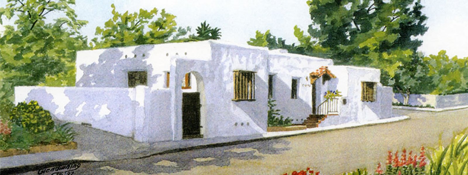 Watercolor painting of a white adobe building with arched doorway and surrounding trees.