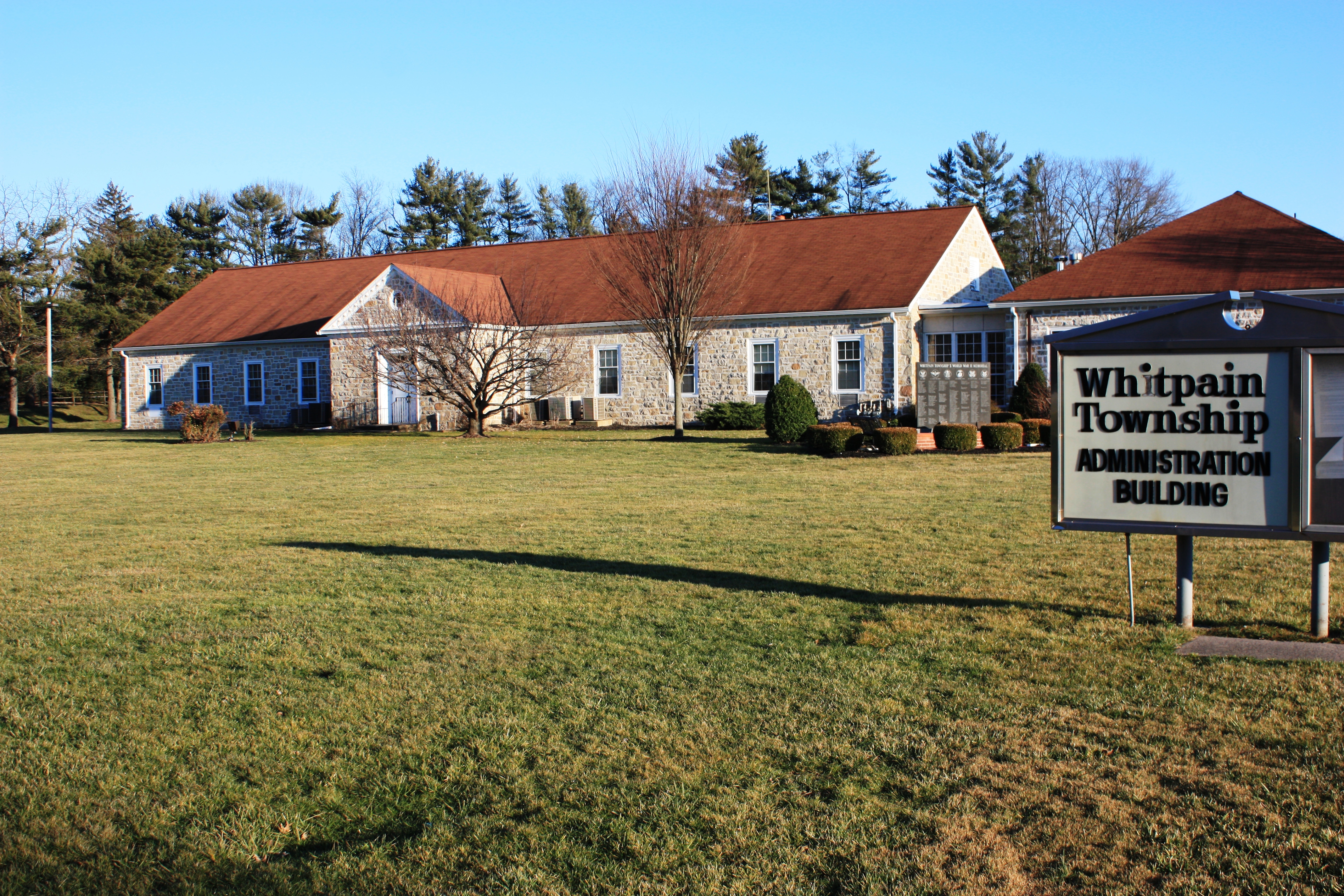 Exterior of the Whitpain Township municipal building on a clear day.