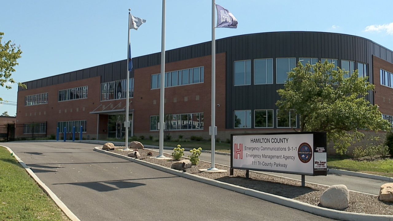 Exterior of the Hamilton County Emergency Communications 9-1-1 building with flagpoles in front.