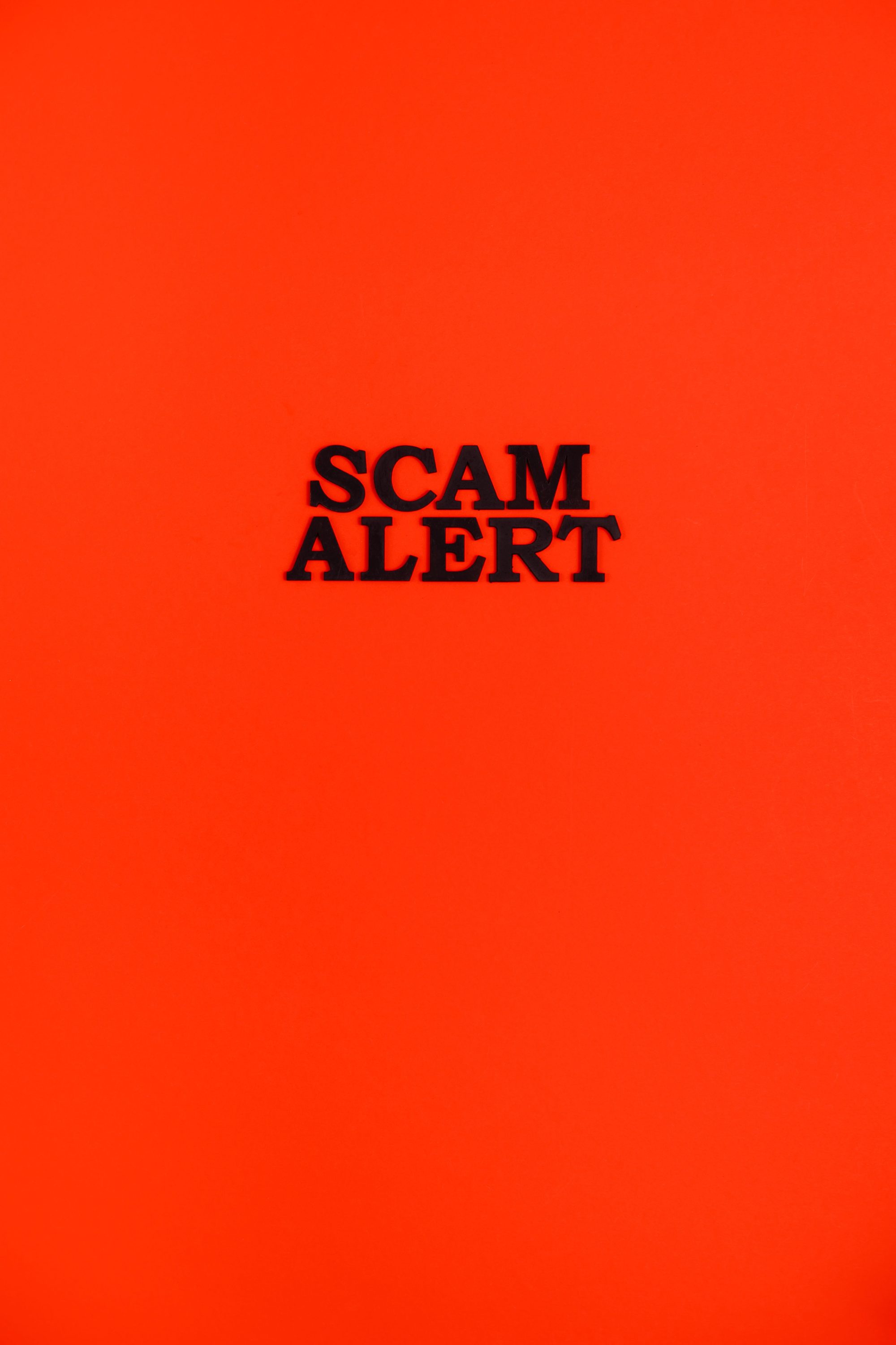 Bold 'Scam Alert' message on a striking red background, highlighting caution and awareness.