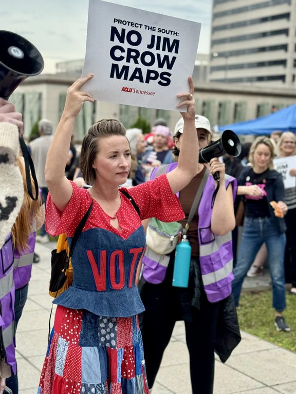 Mandy holding a sign at the state capitol