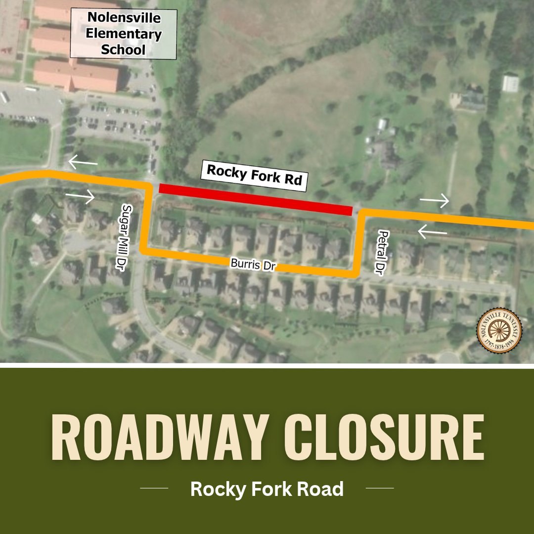 Aerial map showing a red road closure segment and orange detour arrows near an elementary school.