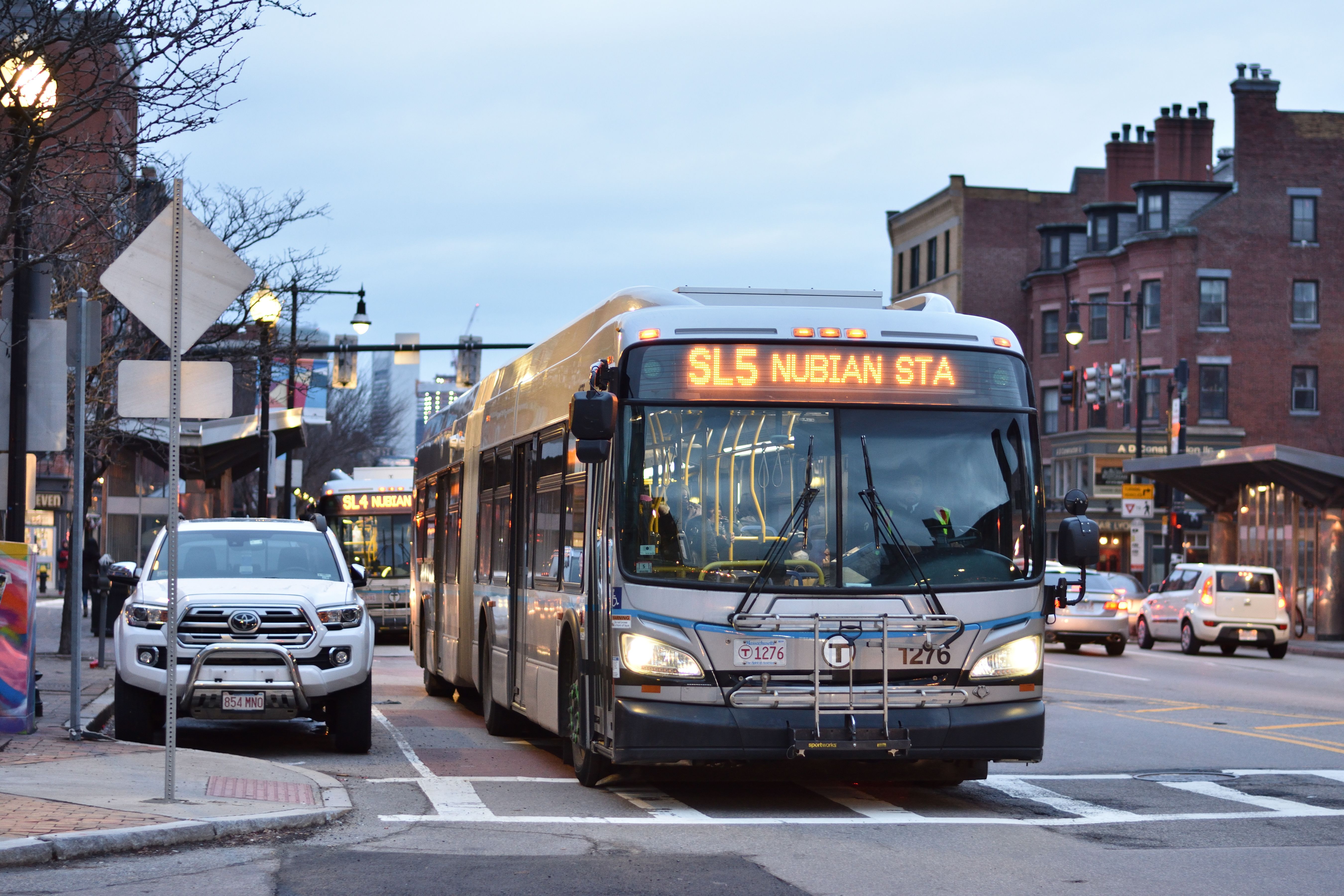 Two articulated MBTA Silver Line buses traveling on a city street.