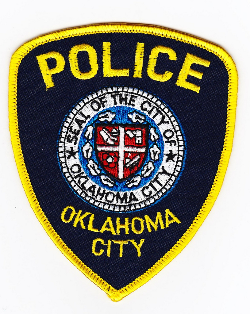 Shield-shaped police shoulder patch with city seal and the words Oklahoma City Police.