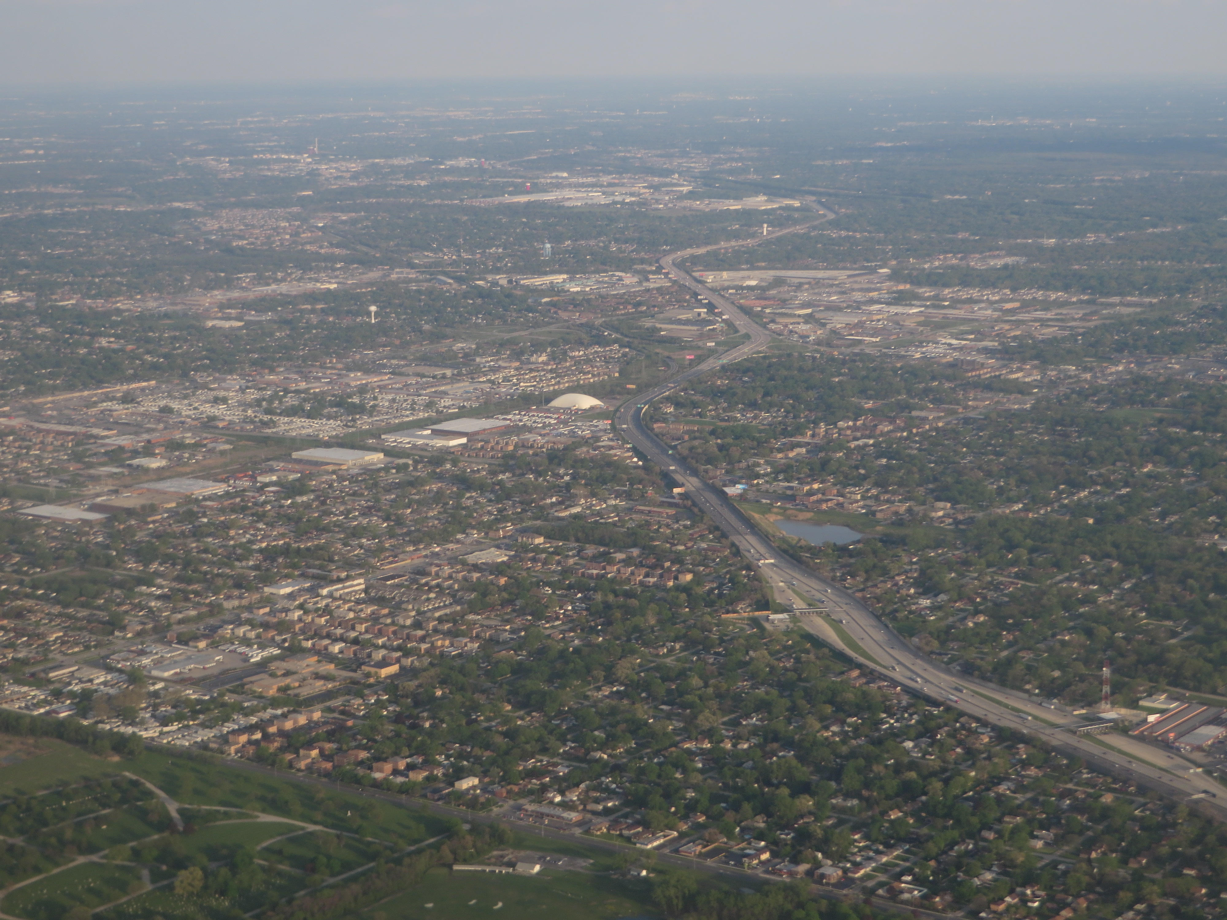 Aerial view of a multi-lane highway interchange with surrounding suburban development.