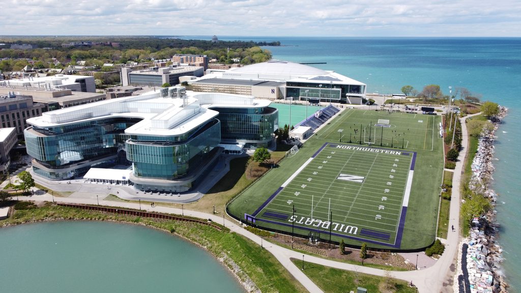 Aerial view of Northwestern University's lakefront athletic campus with fields and Lake Michigan.