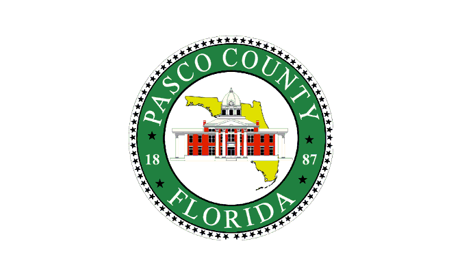 Official flag of Pasco County, Florida, with county seal on green field.