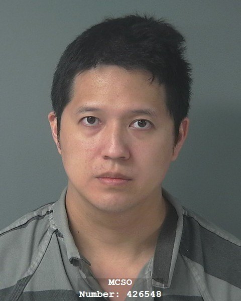 Booking photograph of a man in a gray jail uniform with an MCSO watermark.
