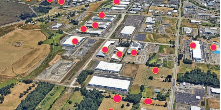 Aerial satellite view of an industrial area with red markers indicating data center locations.