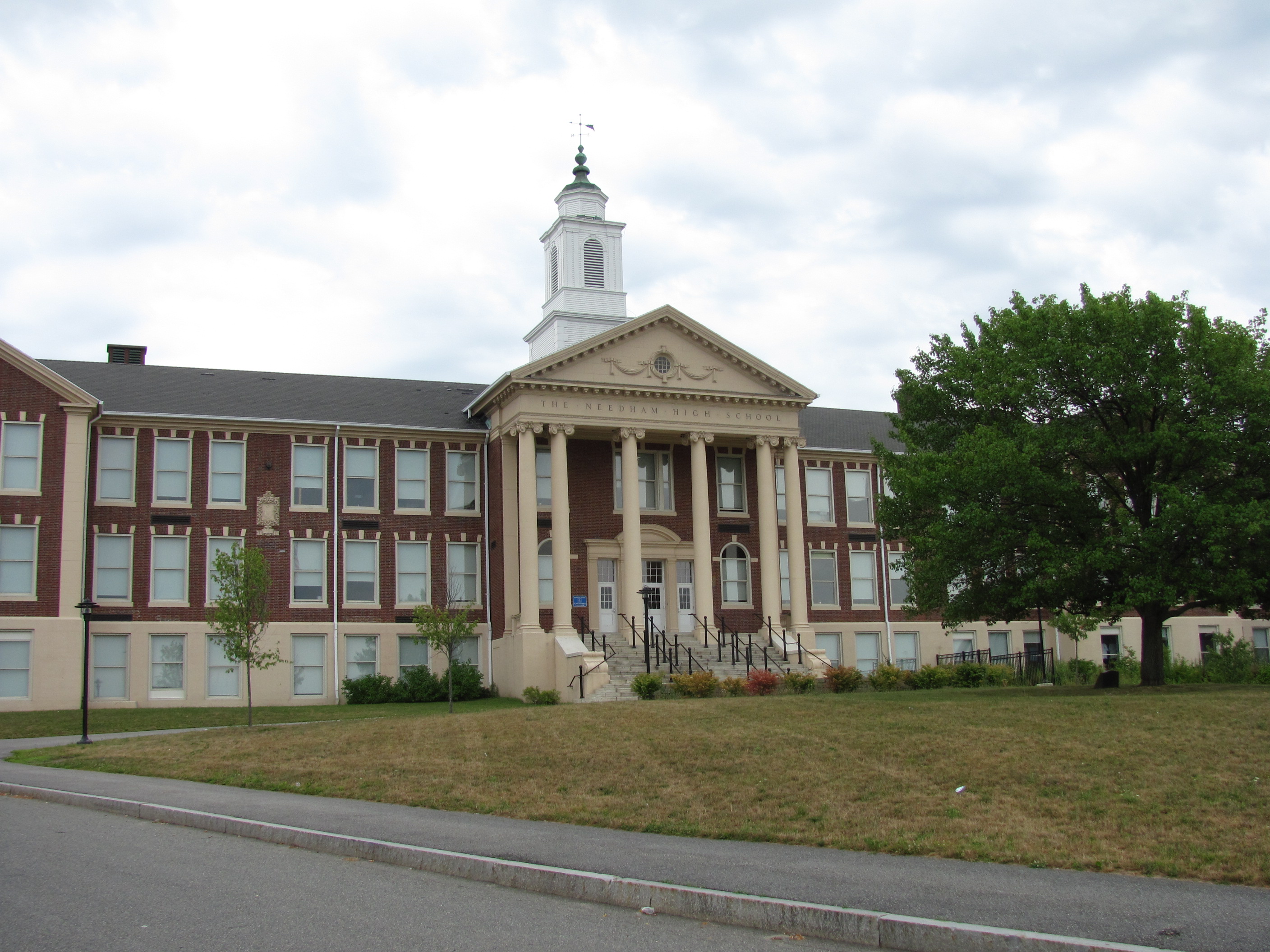 Red-brick high school building with white columned entrance and cupola.