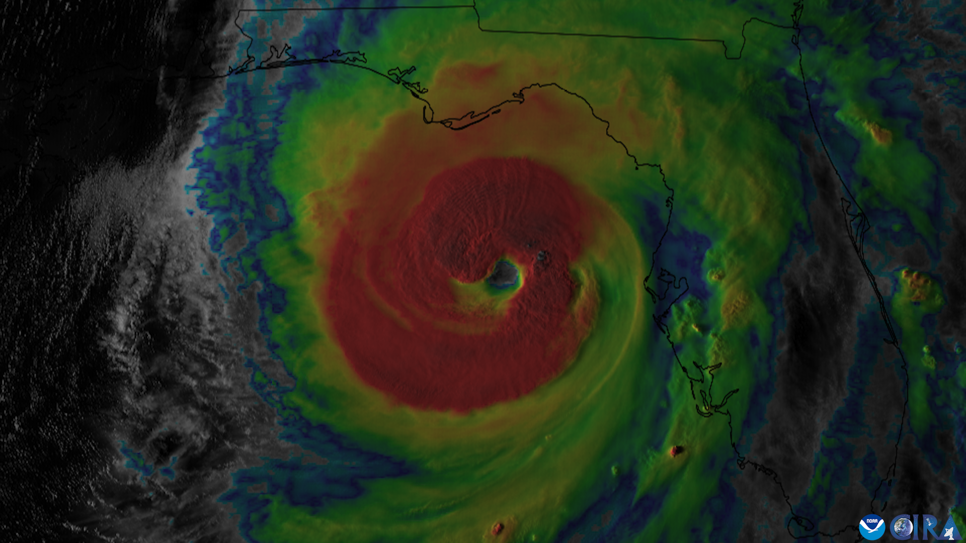 Infrared satellite image of a hurricane with a glowing eye approaching the Florida coastline at night.