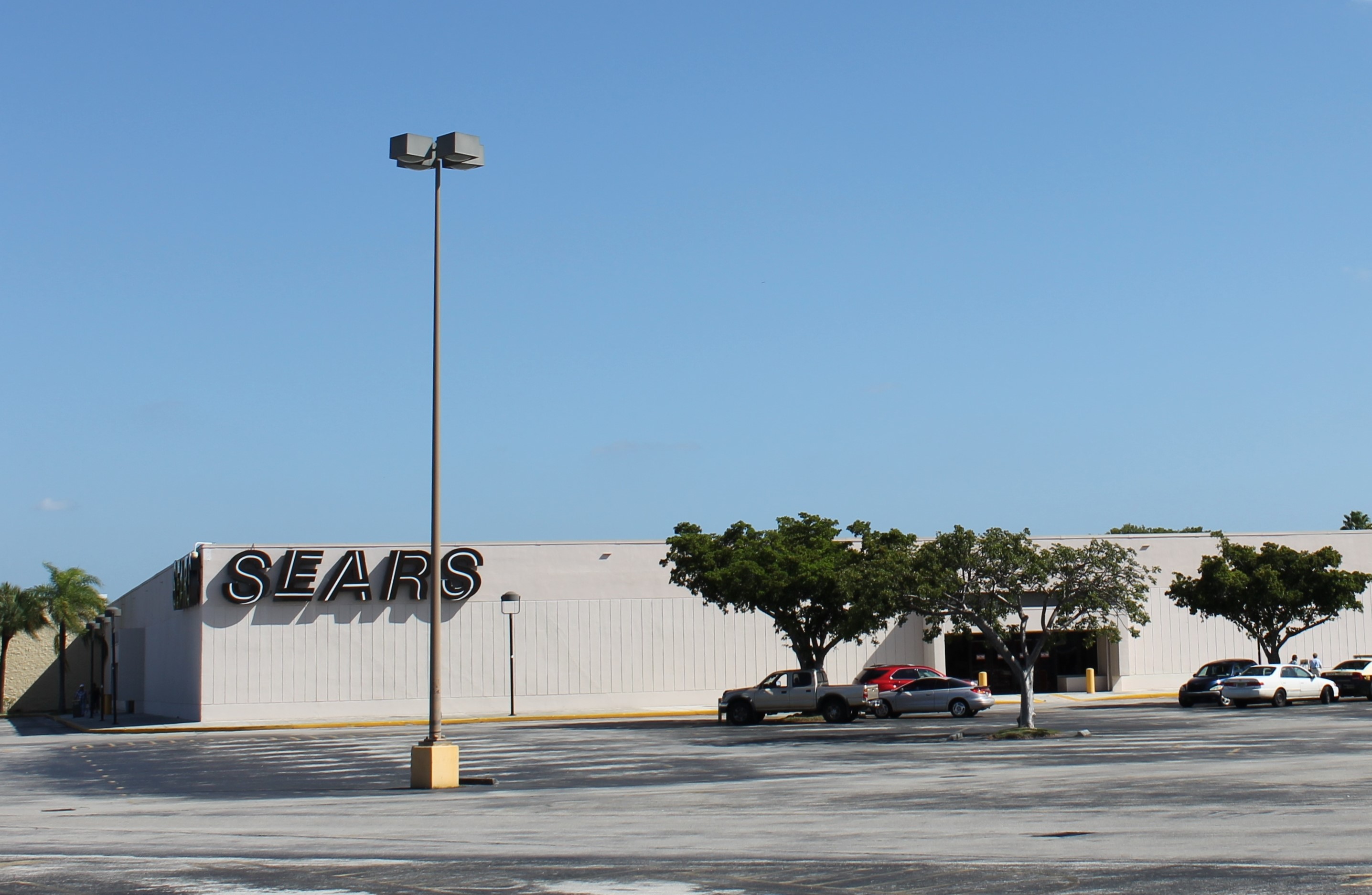 Exterior of a large retail store at a shopping mall with an empty parking lot.