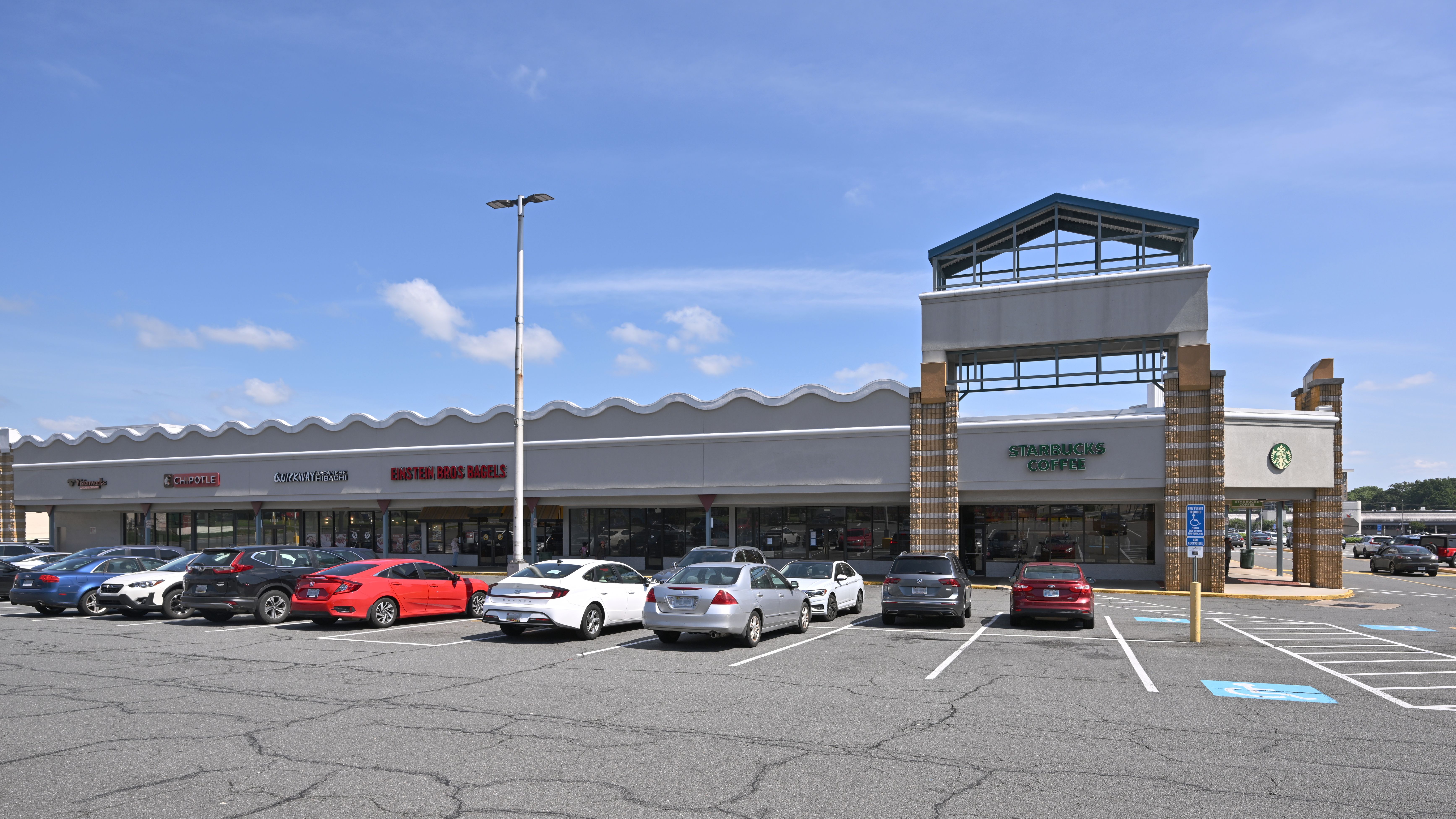 Strip mall storefronts including a Quickway Japanese Hibachi restaurant, with a parking lot in front.