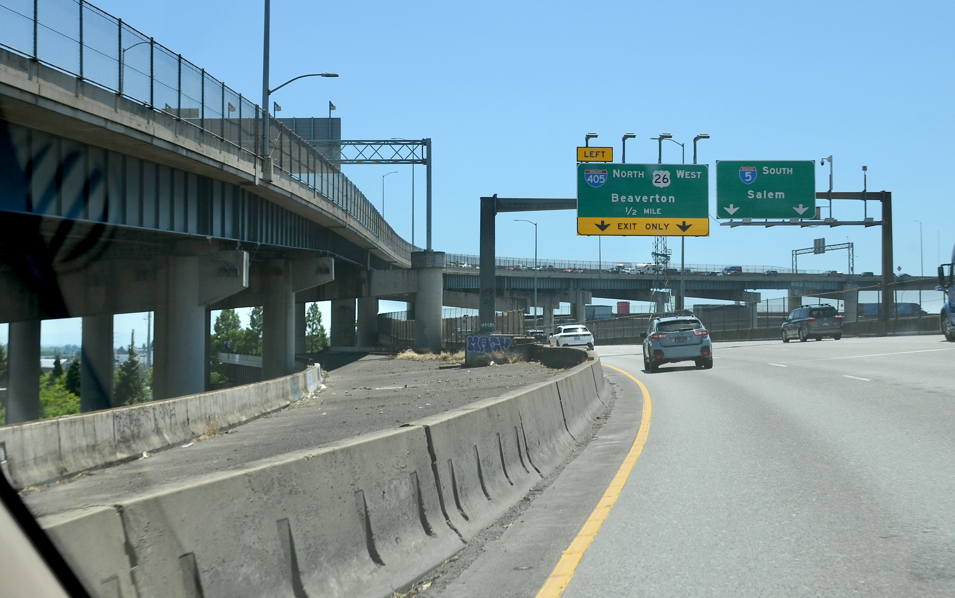 Multi-level freeway interchange with green overhead signs for I-5 north and south.