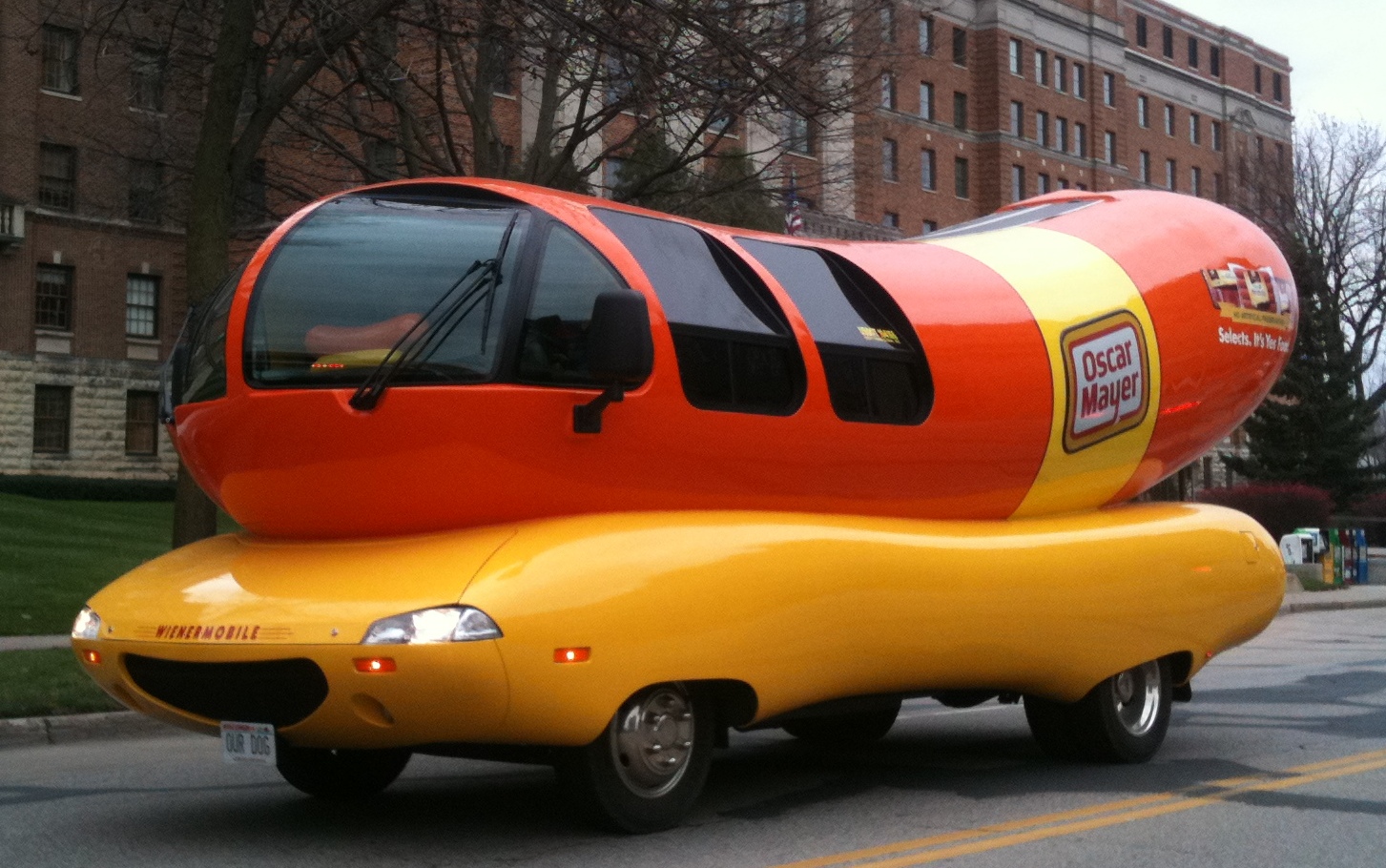 An Oscar Mayer Wienermobile vehicle with Wisconsin "Our Dog" vanity license plates in front of St. Mary's Hospital in Rochester, Minnesota