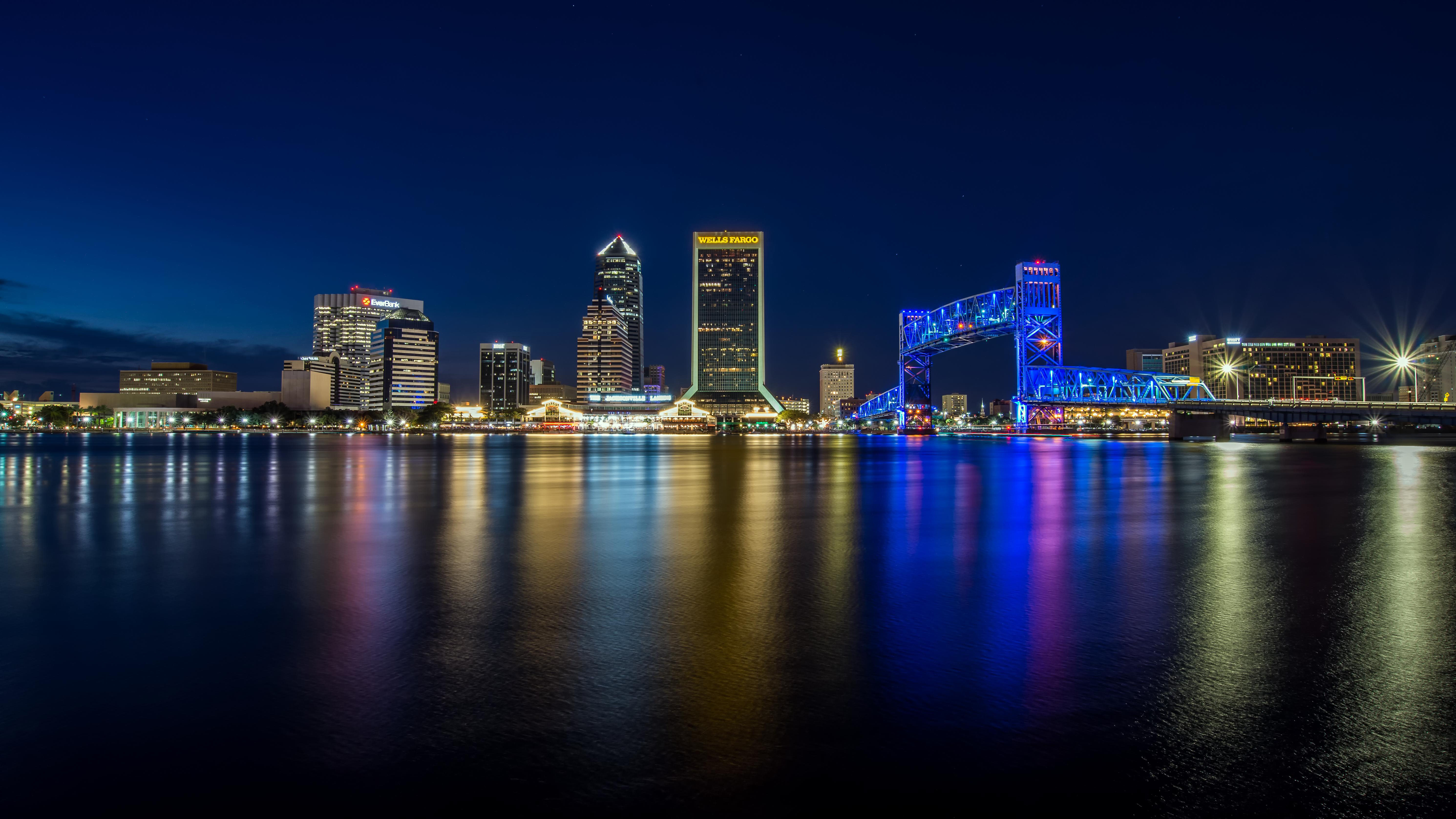 Downtown Jacksonville skyline at night reflected in the St. Johns River.