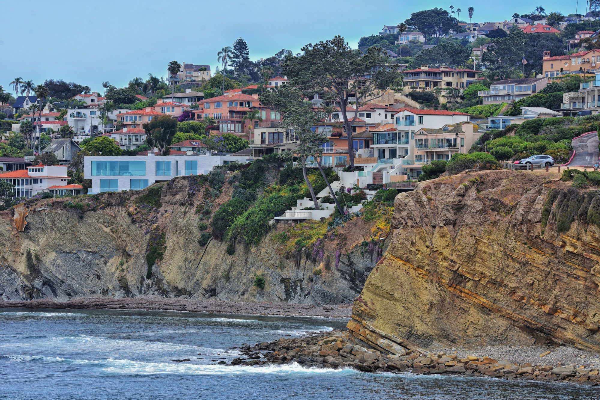 Coastal cliffs and hillside homes overlooking the ocean in San Diego, California.