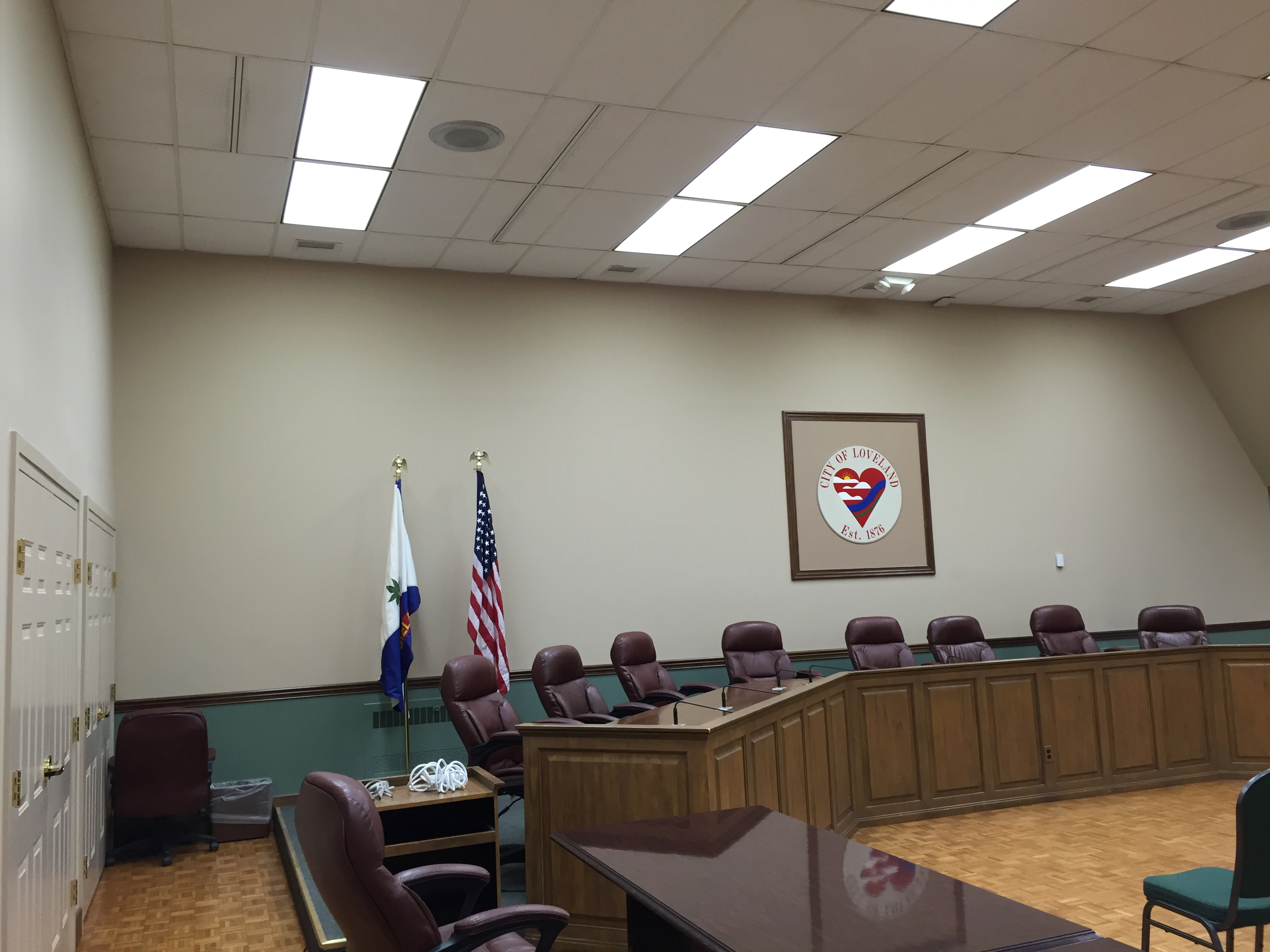 Interior of Loveland City Council chamber with rows of seats and a raised dais.