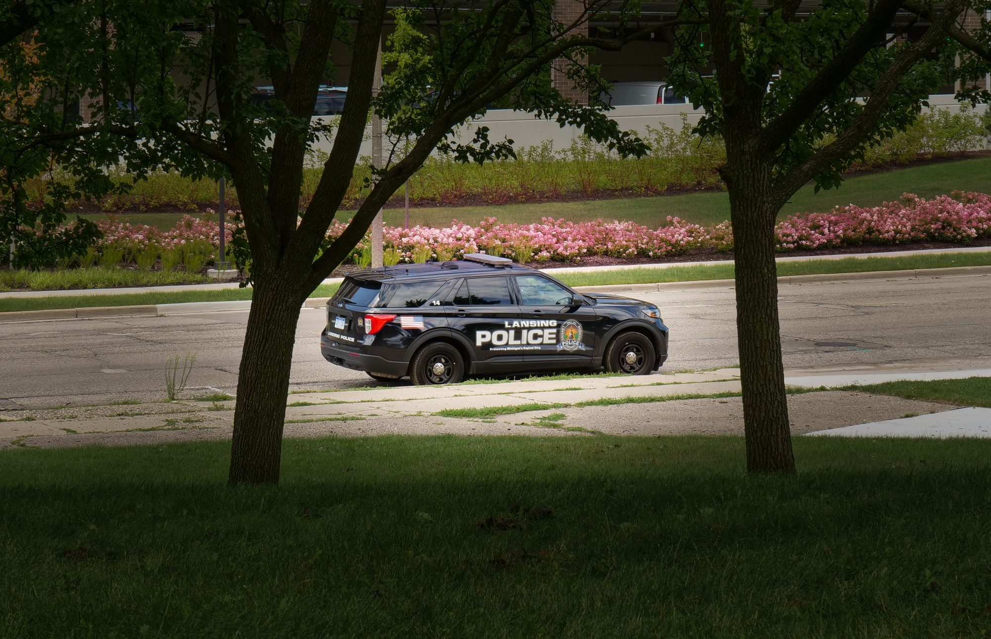A Lansing Police Department patrol vehicle parked in a city park.Lansing police vehicle parked.