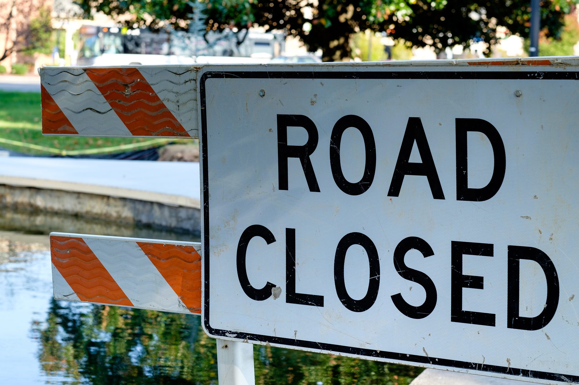 ROAD CLOSED sign & barricade on the pedestrian walkway around the water at Fountain City Lake Park & Duck Pond, Knoxville, Tennessee, USA.