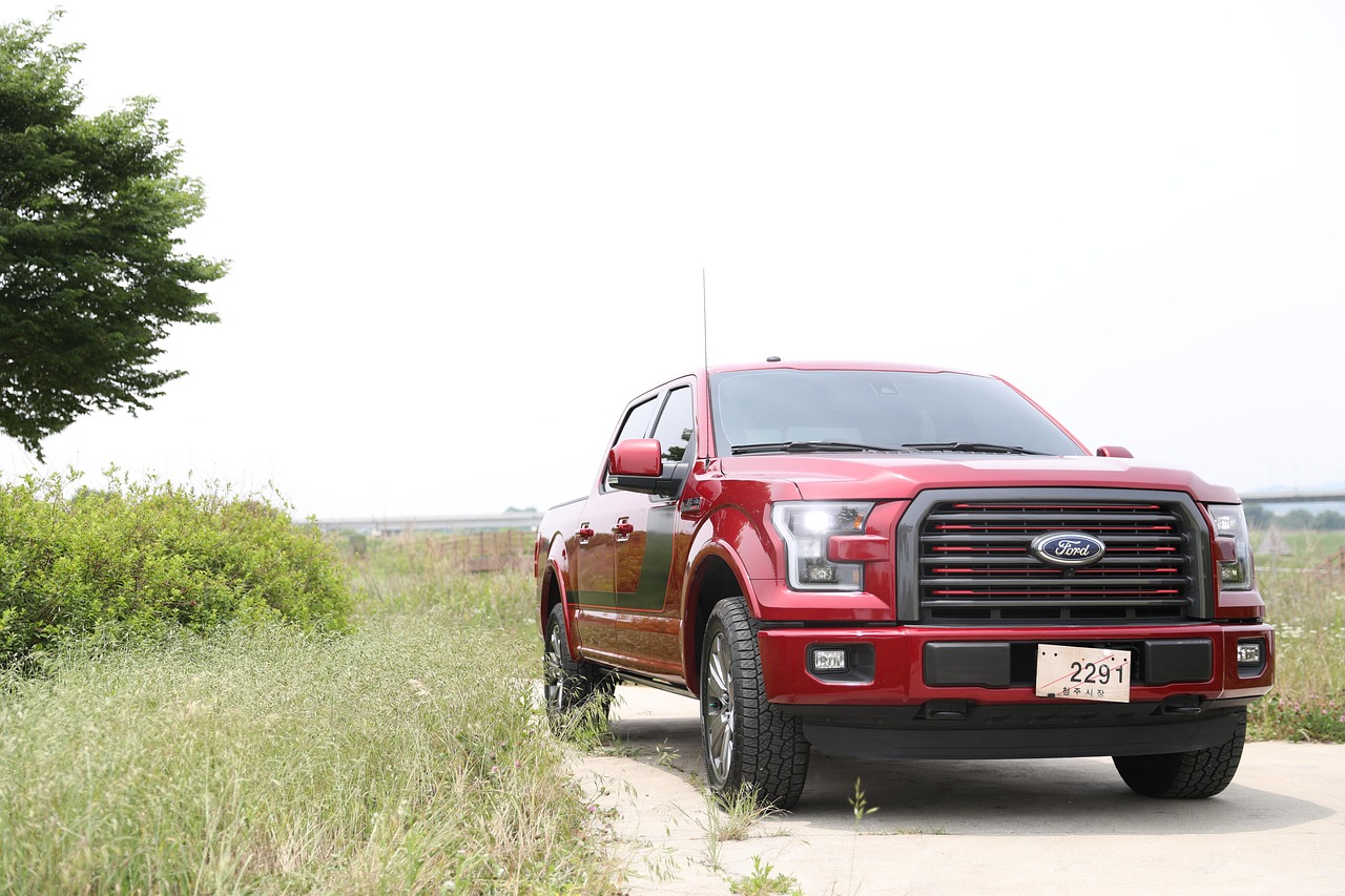Ford pickup truck driving along a road. 