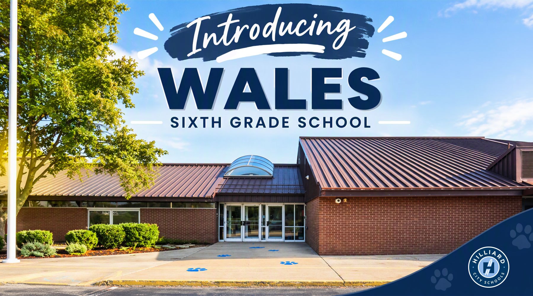 Announcement graphic showing a brick school building with the text 'Introducing Wales Sixth Grade School.'