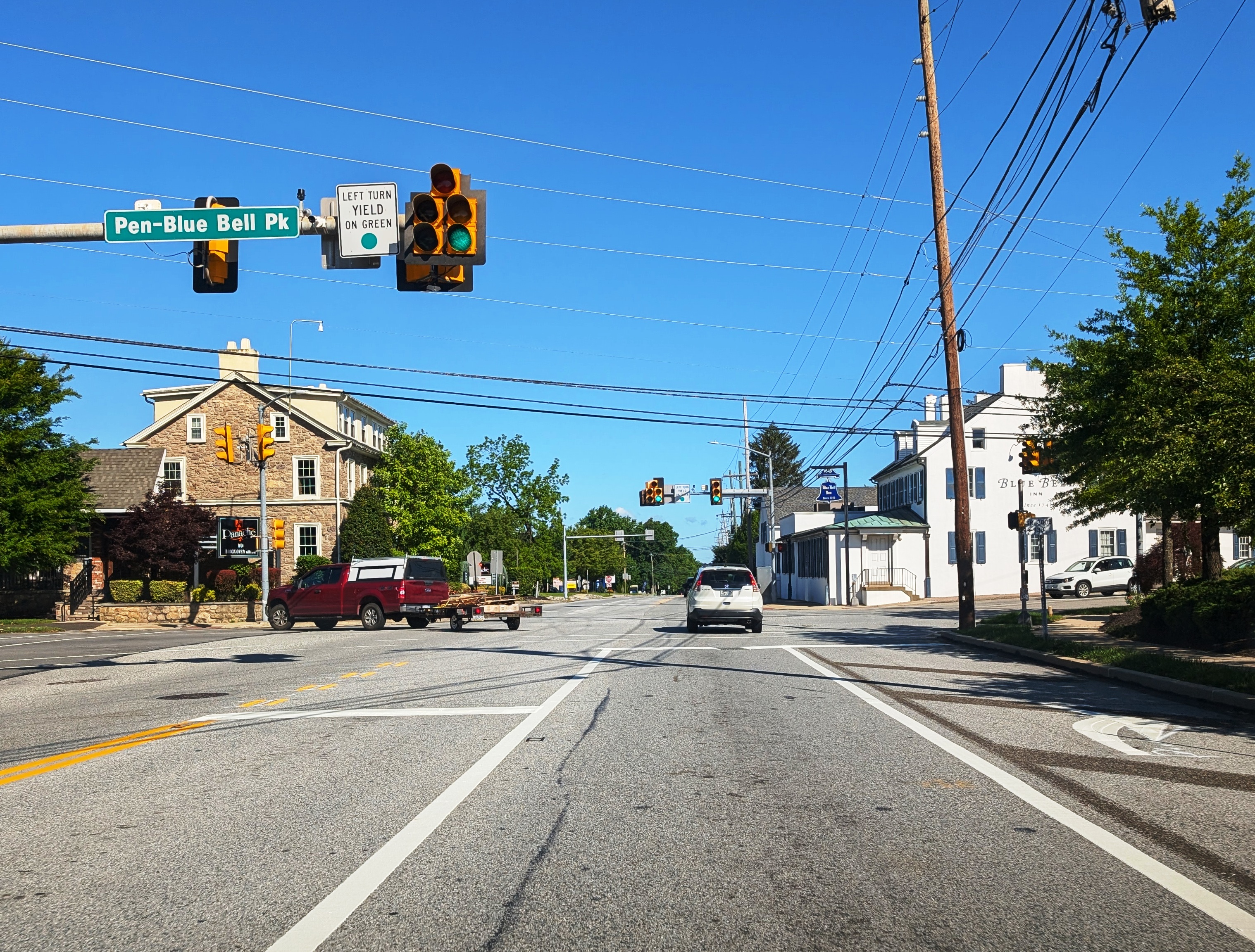 Intersection on Skippack Pike in Blue Bell, Pennsylvania, with traffic signals and stone buildings.