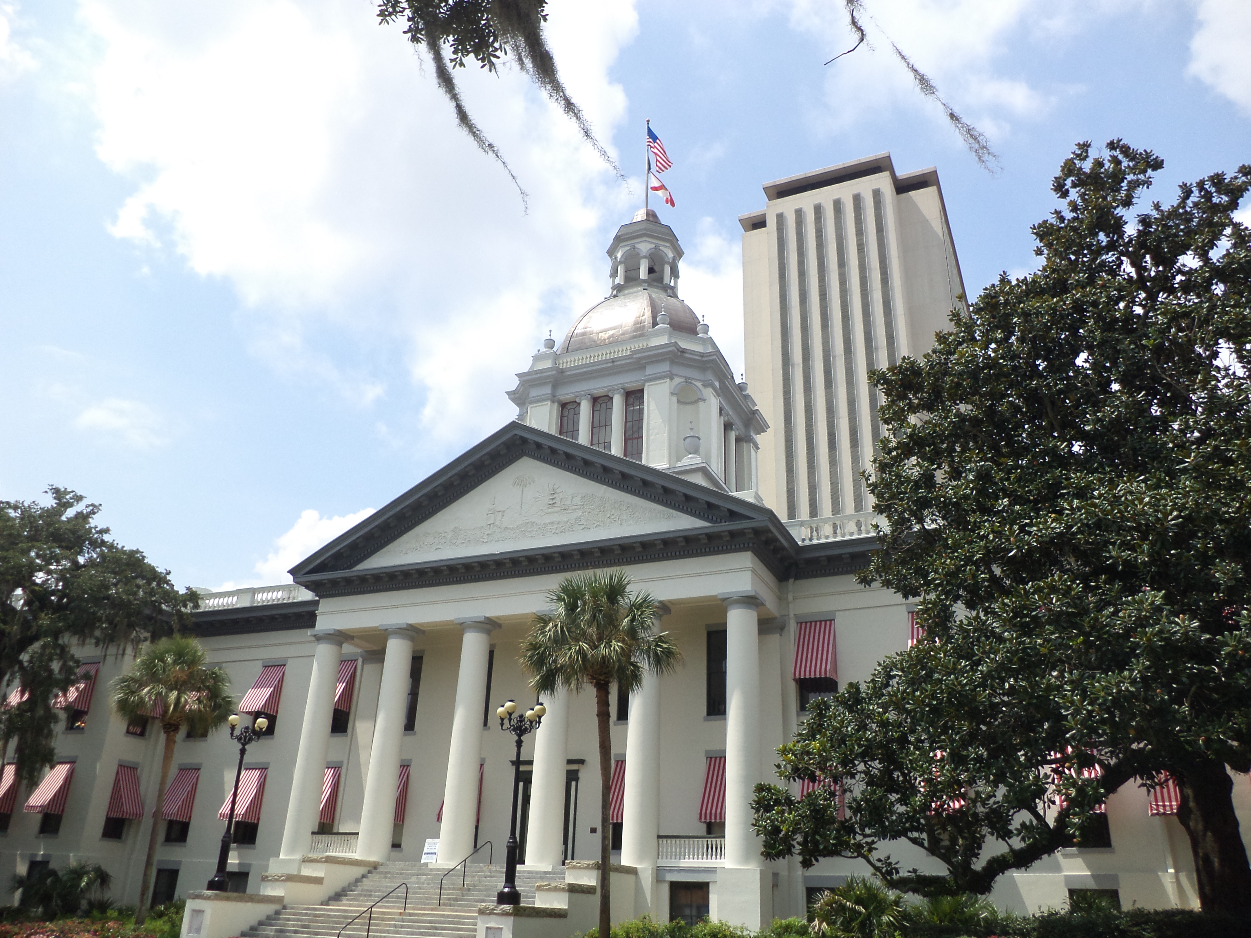 Historic Florida Capitol dome and columns with the modern Capitol tower rising behind it.