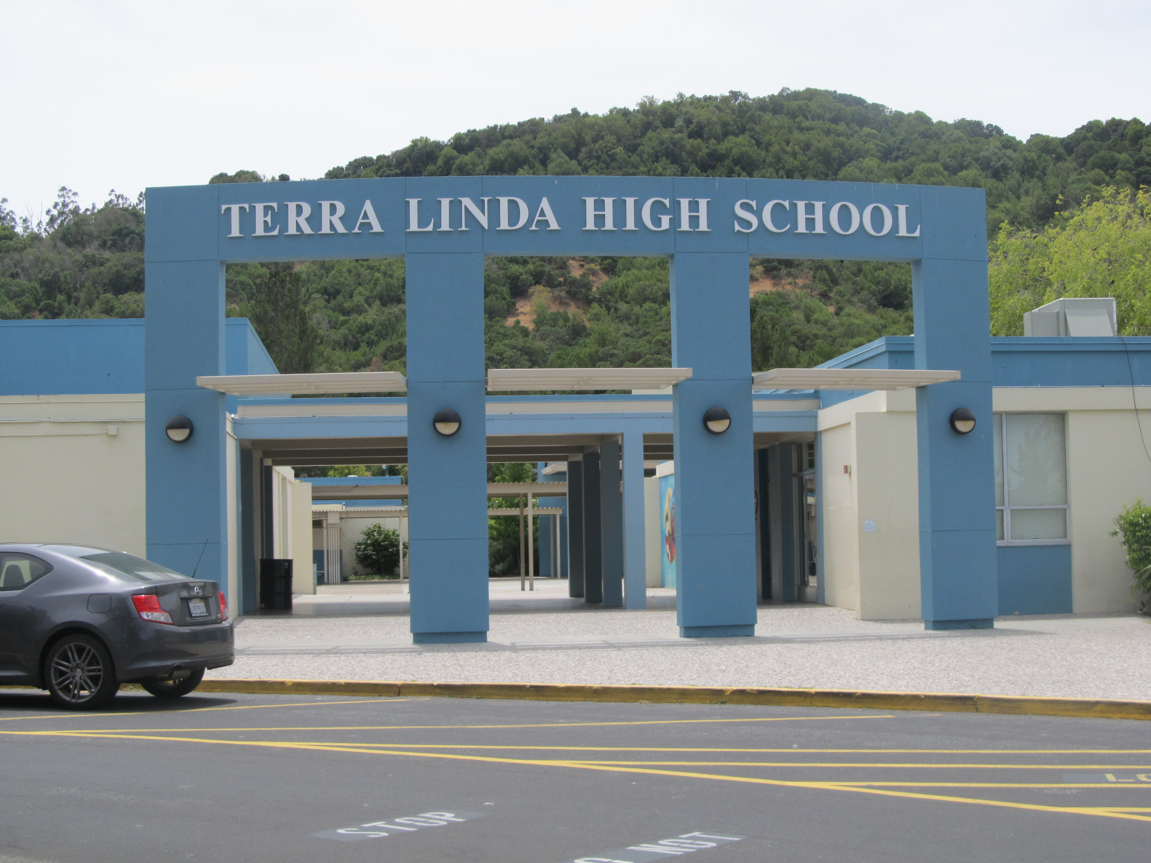 Front entrance of Terra Linda High School with blue-painted columns and the school name displayed above.