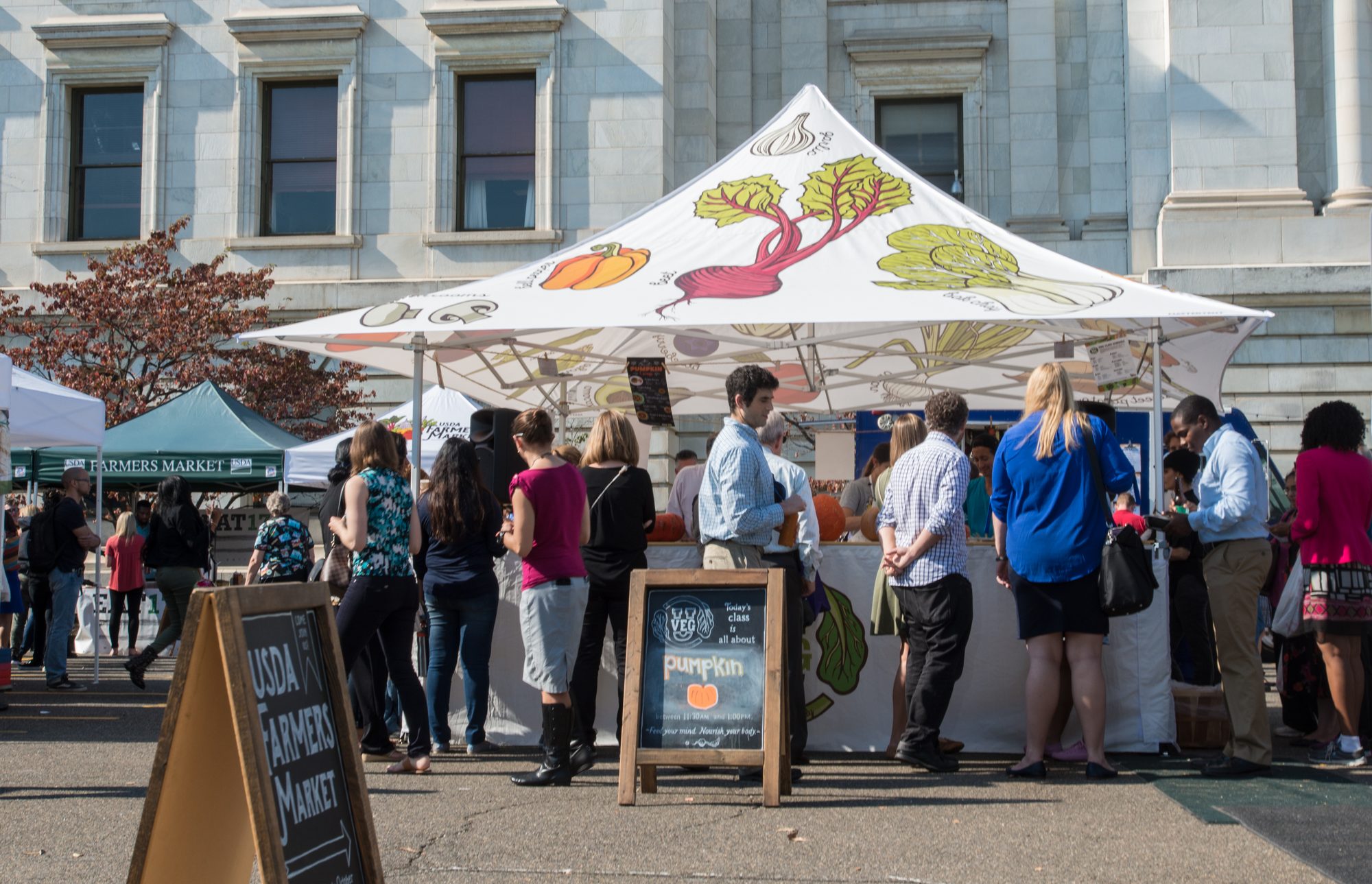 U.S. Department of Agriculture (USDA) Farmers Market âVegU(cation)â tent, where people learn how to how to pick, and store pumpkins; and prepare a curry soup using produce grown in the local area and sold here in downtown Washington, D.C., on Friday October 21, 2016. USDA employees from the Agricultural Marketing Service (AMS), Food and Nutrition Service (FNS), Food Safety and Inspection Service (FSIS) and vendors volunteer as vegetable educators, or âVegUcatorsâ conducting free 10-minute fruit and vegetable classes. Todayâs âVegUcatorsâ are USDA AMS Standardization Specialist David G. Horner, talking about pumpkins and âVegUâ Program Coordinator Sara Pellegrino, preparing and talking about the recipe. The featured (edible) pumpkins are the large orange and flat Cinderella pumpkin, the orange fluted and flat Fairytale pumpkin, the four-lobed crowned orange and beige Monkeyâs Butt pumpkin, the deep orange and rough surfaced Warty Red Thing pumpkin, the small (mainly decorative) Munchkin pumpkin, the orange and the white Sugar pumpkins, the large green-grey flat Jarrahdale pumpkin, and the orange round Peanut pumpkin with portions of the surface that resemble the color and texture of a peanut. During this season of the outdoor USDA Farmers Markets, 26 recipes will be taught at the VegU tent. Their scheduled demonstration dates are the peak harvest time to look for these foods. The goal is to increase fruits and vegetables in meals and help people understand what is in season. Guests can receive a free recipe card, and can start shopping for ingredients at the market.
www.usda.gov
www.usda.gov/farmersmarket 
peoplesgarden.usda.gov
@USDA_AMS 

USDAFarmersMkt
USDA Media by Lance Cheung.

PUMPKIN CURRY SOUP
Yields 8 cups
Prep Time: 1 hour | Cook Time: 20 minutes | Total Time: 1 hour 20 minutes
1 tbsp. olive oil
1 medium onion, ï¬nely chopped
3 garlic cloves, minced 
3 lb. fresh sugar pumpkin 
3 cups vegetable stock
1 tbsp. curry powder
1 tsp. chili powder
Salt and pepper to taste 
1. Preheat oven to 350Â° F.
2. Remove pumpkin stem and slice pumpkin in half using a sharp knife. Remove pumpkin seeds and stringy innards with a spoon. Discard or save seeds to roast later on.
3. Brush pumpkin halves with oil and place face down on a parchment-lined baking sheet. Bake for 45 minutes or until tender.
4. Remove from oven and let cool. Separate pumpkin ï¬esh from skin. PurÃ©e the pumpkin ï¬esh in a blender or food processor. (Process to your preference of a smooth to chunky texture. See photo album for examples.)
5. In a pot, heat onion and garlic over medium heat. Add vegetable stock, purÃ©ed pumpkin, curry powder and chili powder.
6. Bring soup to a boil then reduce heat and simmer for 10
minutes. 
Note: Each pound of sugar pumpkin should yield 1 cup of pumpkin purÃ©e.
Adapted from Â© My Darling Vegan 2016
Recipe 25 of 26
October 2016
THIS WEEK VEGU IS ALL ABOUT PUMPKINS
Three diï¬erent species in the Curburita genus are known as pumpkins (Cucurbita pepo, C. maxima, C. moschata). Pumpkins are typically planted in early summer and harvested in fall. Pumpkins can be stored for several months after harvesting due to their thick outer skin. There are countless diï¬erent varieties of pumpkins grown in the United States ranging in size from 2 pounds to 100 pounds and in an array of colors including orange, yellow, green, and white. One of the most common pumpkin varieties used for cooking and baking is Sugar Pie (also known as pie pumpkins), which has thin skin and sweet ï¬esh making it ideal for eating. 
HOW TO PICK
Look at size. Choose pumpkins that feel solid and heavy for their size. Check for blemishes. Pick pumpkins that are unblemished, have consistent color and have the stems attached. 
Feel for freshness. Press on the bottom of the pumpkin. If it is ï¬exible or has several soft spots it may indicate that it is not as fresh. 
HOW TO PREPARE
To cook a fresh pumpkin, ï¬rst wash and dry the whole pumpkin. Remove the stem and slice the pumpkin in half using a sharp knife. Clean out the inside, removing the seeds and ï¬brous strings. Place the halves on a cookie sheet or tray and bake at 350Âº F for about 30-45 minutes depending on the size. Once cooled, peel oï¬ the skin using a knife and chop the pumpkin into cubes, or purÃ©e the ï¬esh in a blender or food processor. Use cooked pumpkin purÃ©e or cubes in pies, cakes, baked goods, soups, and stews. 
HOW TO STORE 
Pumpkins require cool and dry conditions for best storage. Optimal temperature is between 50-55Âº F and humidity of 50-70%. If stored properly, certain varieties of pumpkin can last up to two months.
Tip: Store cooked, cubed or purÃ©ed pumpkin for up to one week in the refrigerator. 
Advice about freezing. Freezing pumpkin is a great option. To freeze, ï¬rst roast pumpkin in the oven (as outlined on the other side of this handout) and place cooked cubes or purÃ©ed pumpkin into freezer bags. To freeze raw cubes, ï¬rst peel the pumpkin skin and remove seeds and ï¬brous strings. Chop pumpkin into 1-inch cubes and store loosely in freezer bags. Frozen pumpkin can be stored for 9 months to 1 year. 
FUN FACTS
â¢Pumpkins originated in Central America and are botanically a fruit.
â¢At the ï¬rst Thanksgiving feast in 1621, the pilgrims did not serve pumpkin pie, rather, they served stewed pumpkin.
â¢Pumpkins are members of the Cucurbitaceae family, which includes squash, zucchini, watermelon, cucumbers and gourds.
â¢Over 50,000 acres of pumpkins were harvested in the United States in 2014, producing 1.3 billion pounds of pumpkins.
â¢China and India are the worldâs top pumpkin producers; U.S. is ranked ï¬fth.
â¢Illinois is the top pumpkin producing state in the U.S. followed by California, Ohio and Pennsylvania.
â¢Pumpkin is an excellent source of beta-carotene, the precursor to vitamin A.
â¢99% of pumpkins grown in the U.S. are sold for decoration.

GET A VEGUCATION EVERY FRIDAY BETWEEN 11:30 AM AND 1:00 PM, MAY TO OCTOBER, IN THE VEGU TENT AT THE USDA FARMERS MARKET. SHORT 10 MINUTE CLASSES ARE FREE. THE MARKET IS LOCATED ON THE CORNER OF INDEPENDENCE AVENUE AND 12TH STREET, SW, IN WASHINGTON, DC 20250.