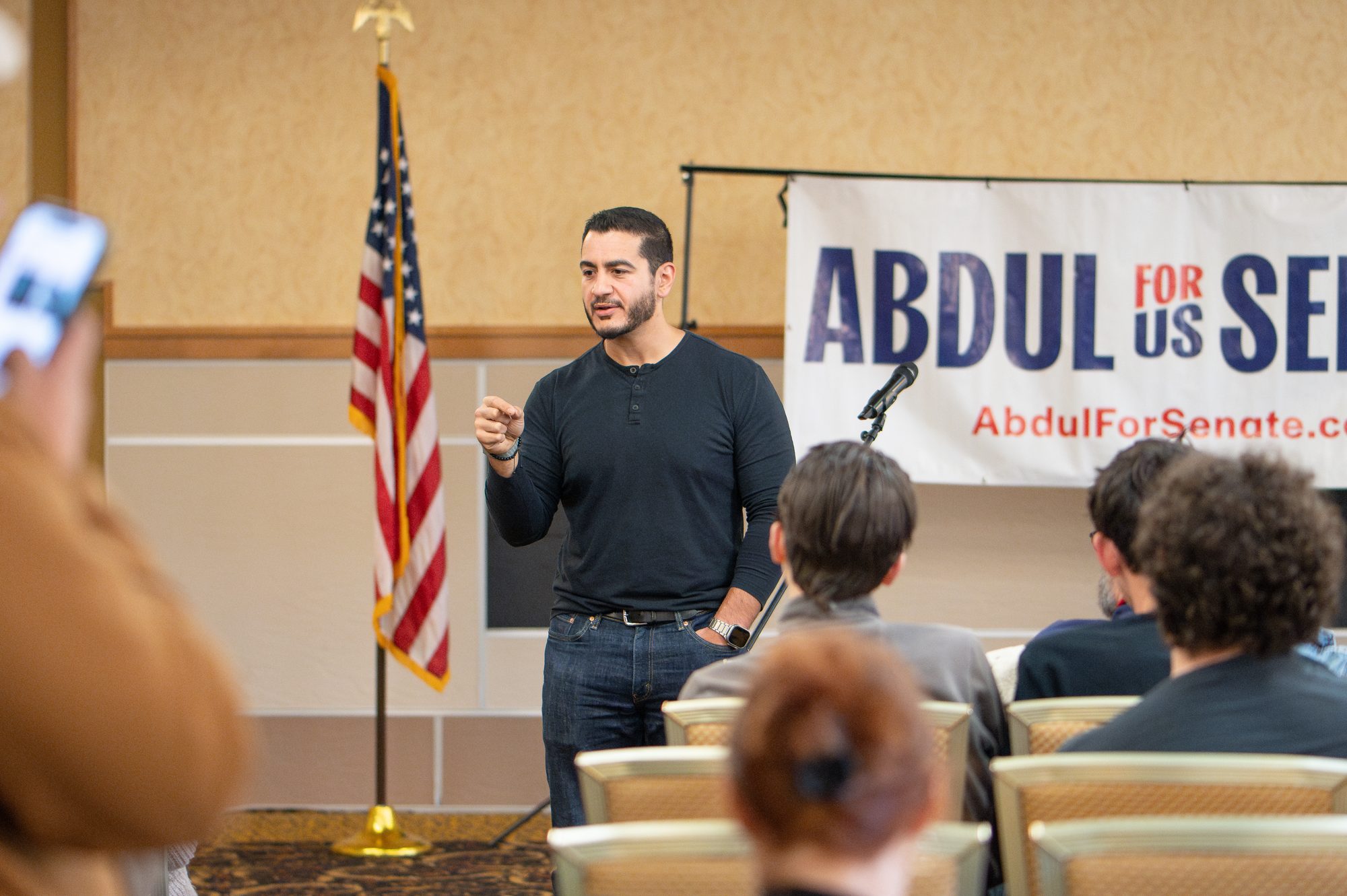 Abdul El-Sayed talks with a group of supporters at a campaign event.