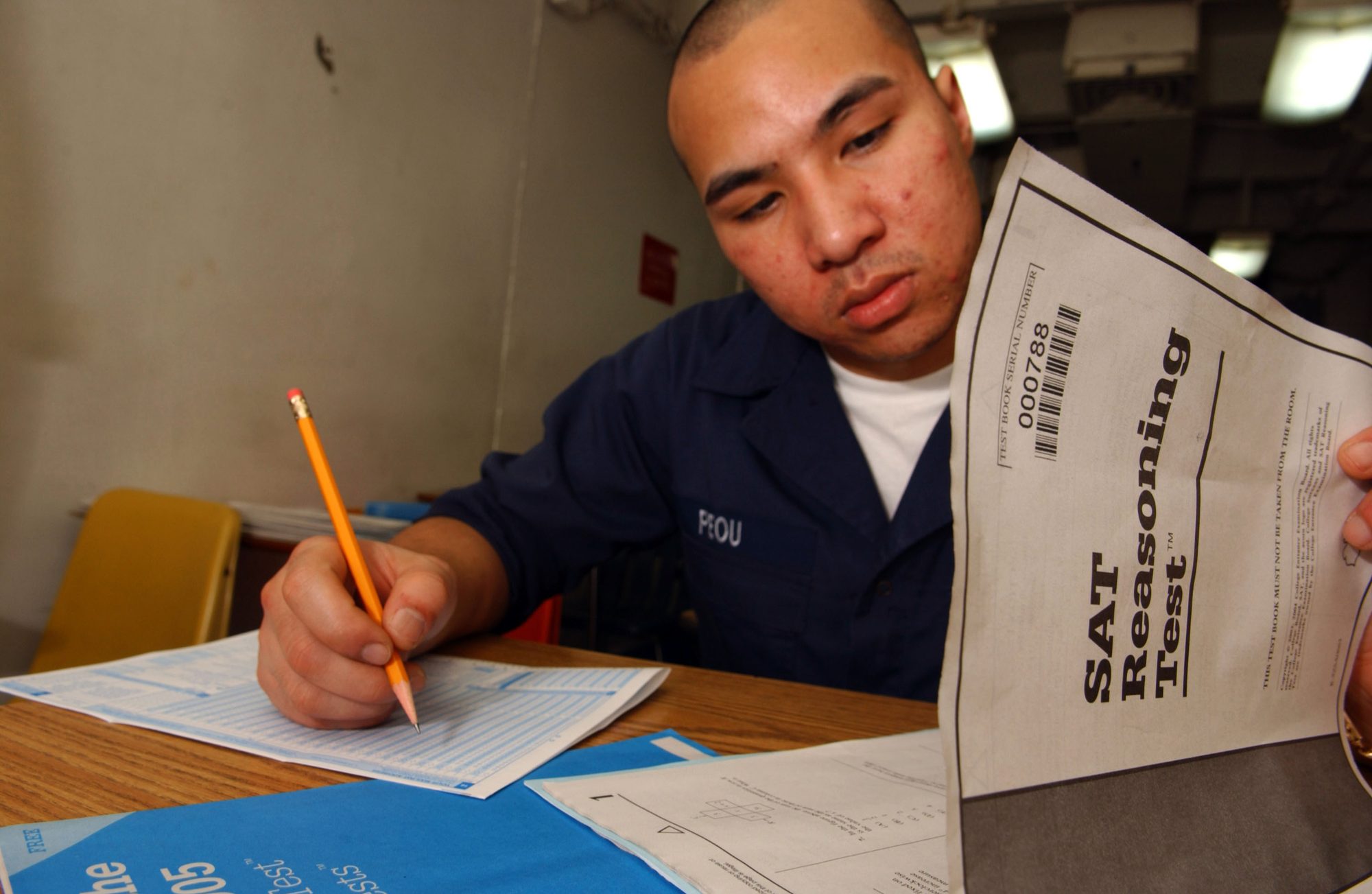 Pacific Ocean (Feb. 23, 2004) - Seaman Chanthorn Peou of San Diego, Calif., takes his Scholastic Aptitude Test (SAT) aboard the conventionally powered aircraft carrier USS Kitty Hawk (CV 63). Administering SAT's is one of the continual education services provided by Kitty Hawk's Education Service Office to assist Sailors advance their opportunities in the Navy and civilian sector. Kitty Hawk demonstrates power projection and sea control as the U.S. Navy's only forward-deployed aircraft carrier, operating from Yokosuka, Japan. U.S. Navy photo by Photographer's Mate 3rd Class Jason T. Poplin (RELEASED)