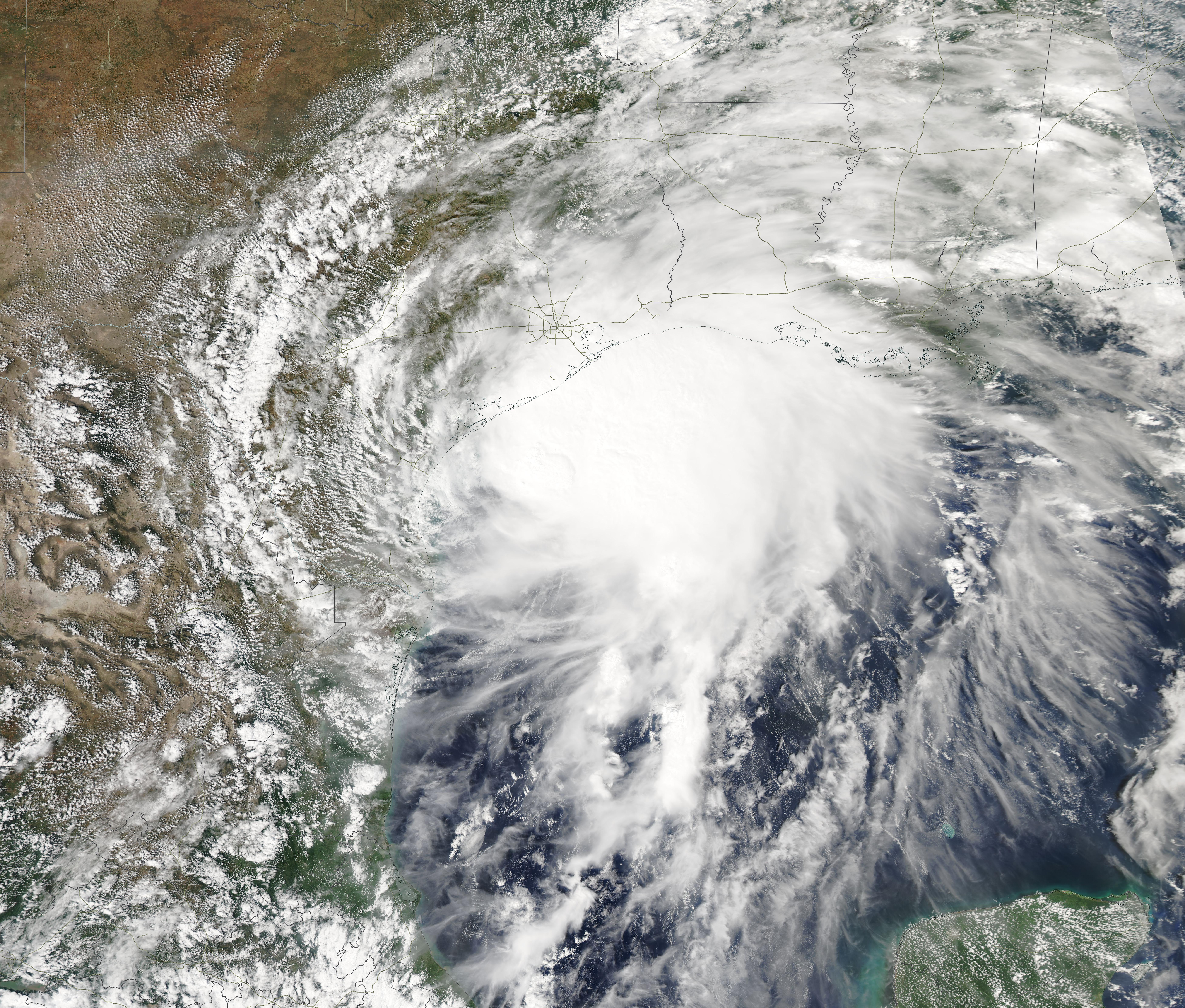Satellite image of a tropical storm with spiral cloud bands over the Gulf of Mexico near the Texas coast.