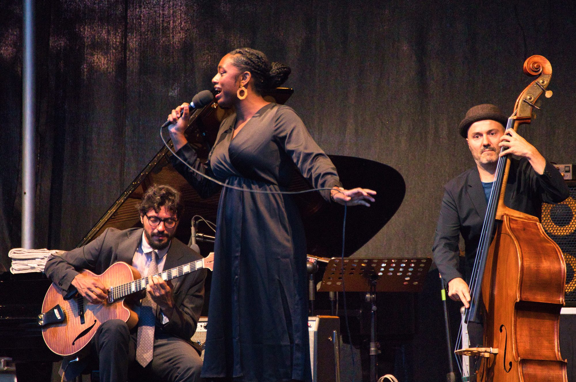 Samara Joy singing on stage with her band at a 2022 jazz festival.